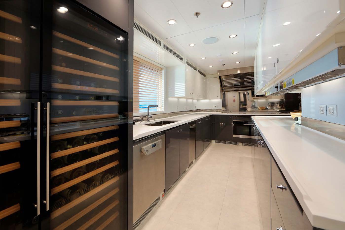 a kitchen with black cabinets aboard PLANET NINE Yacht for Sale