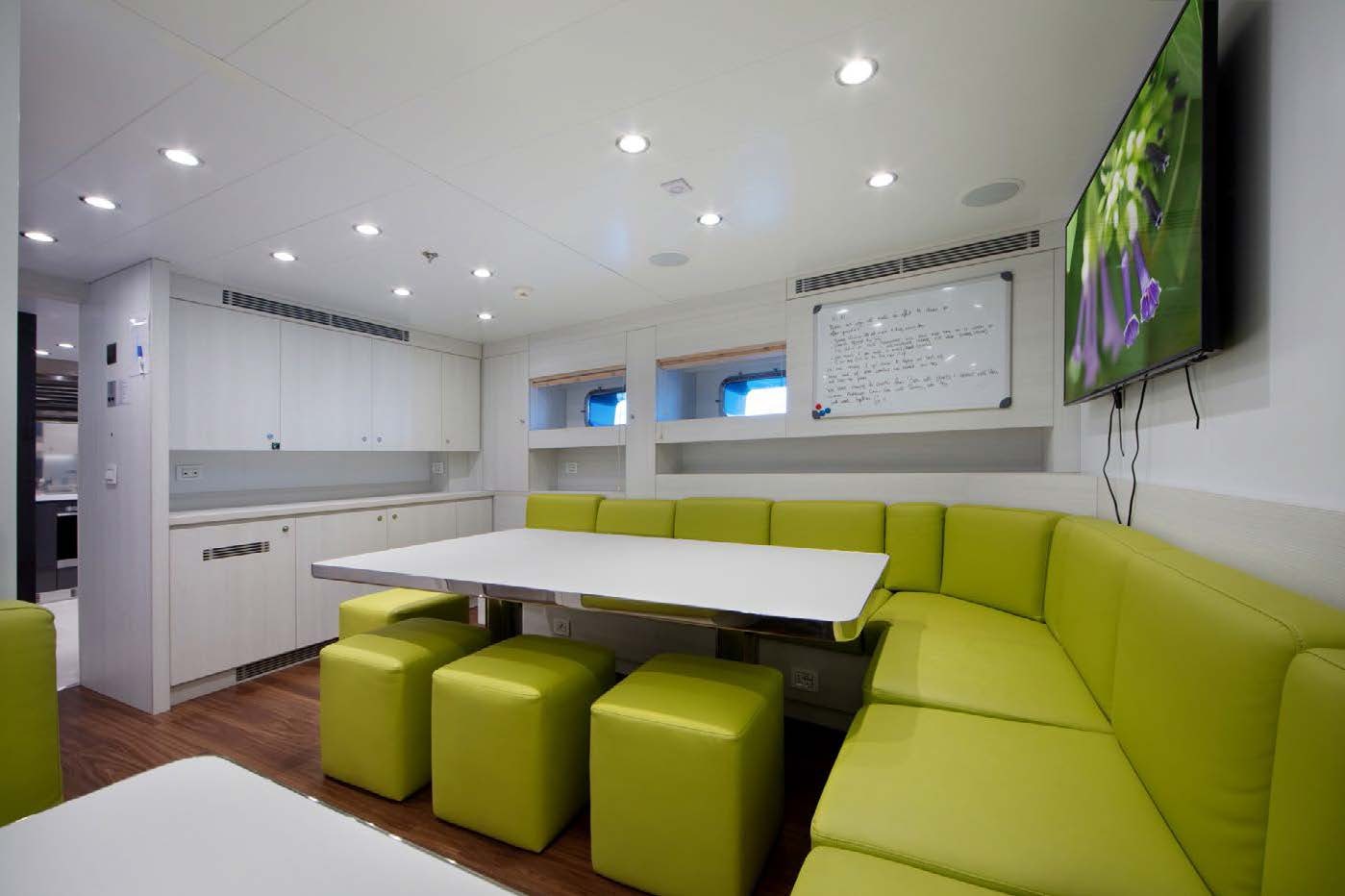 a room with a table and chairs aboard PLANET NINE Yacht for Sale