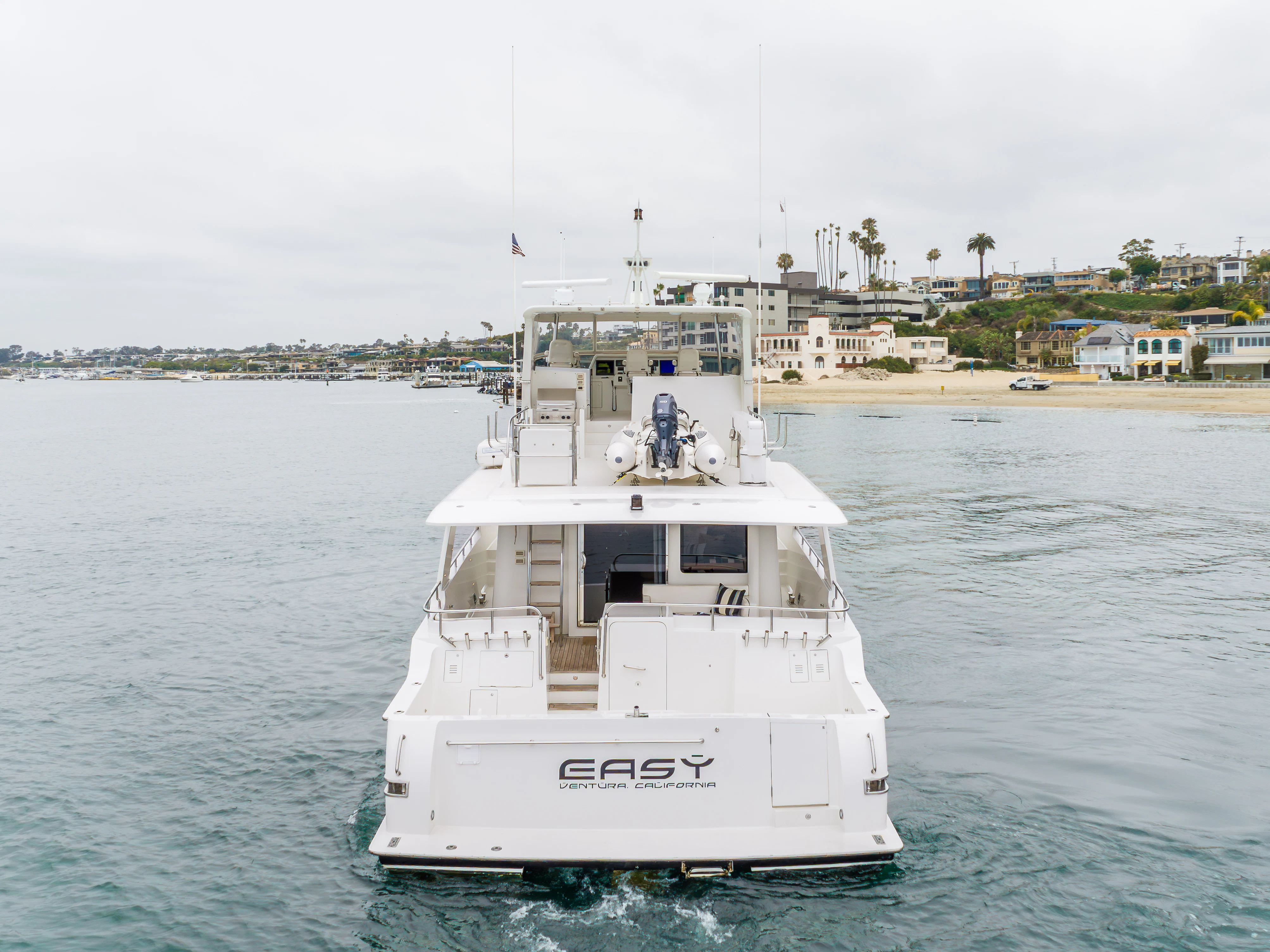 a white boat in the water aboard EASY Yacht for Sale