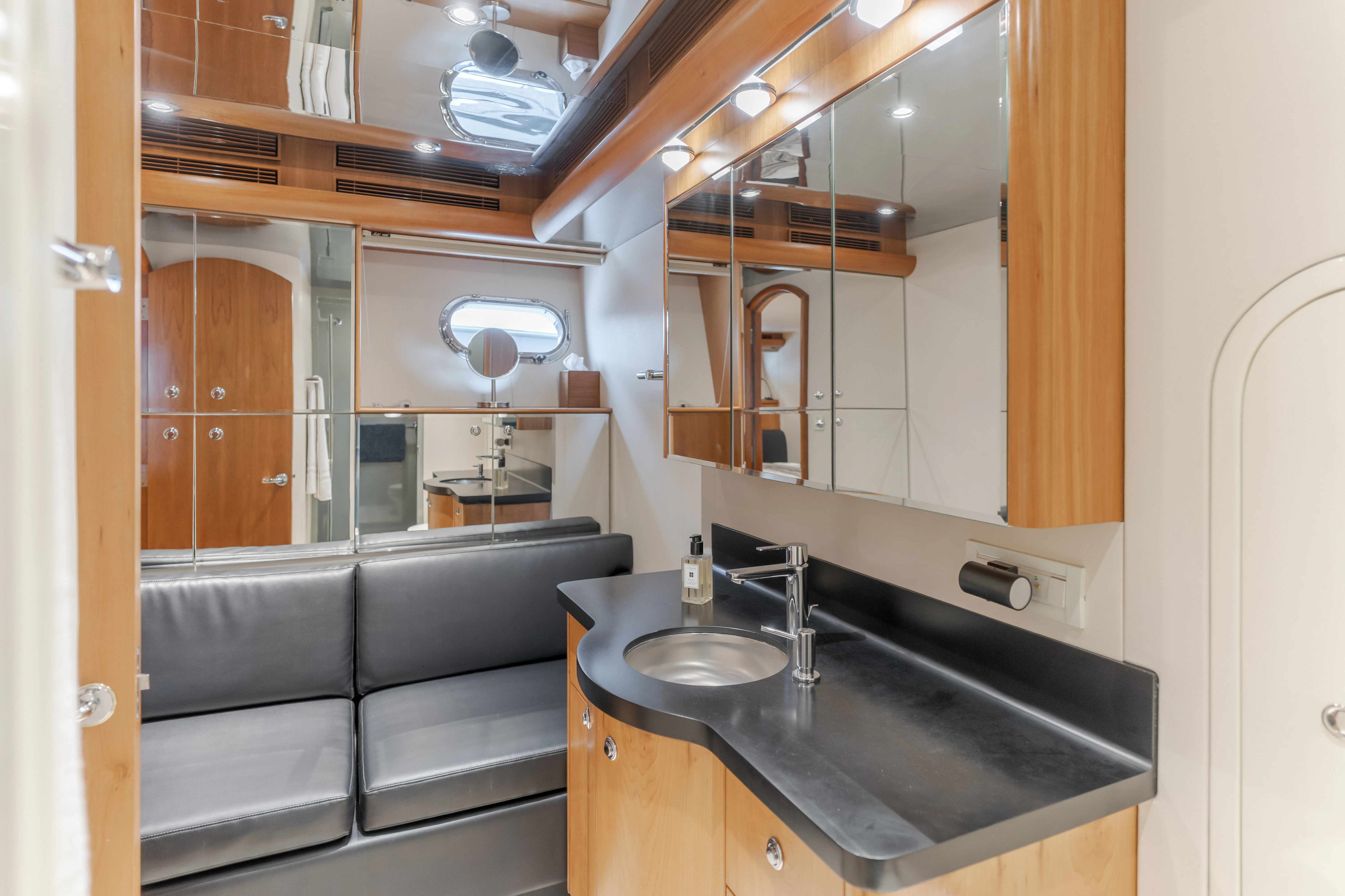 a bathroom with a sink and cabinets aboard EASY Yacht for Sale