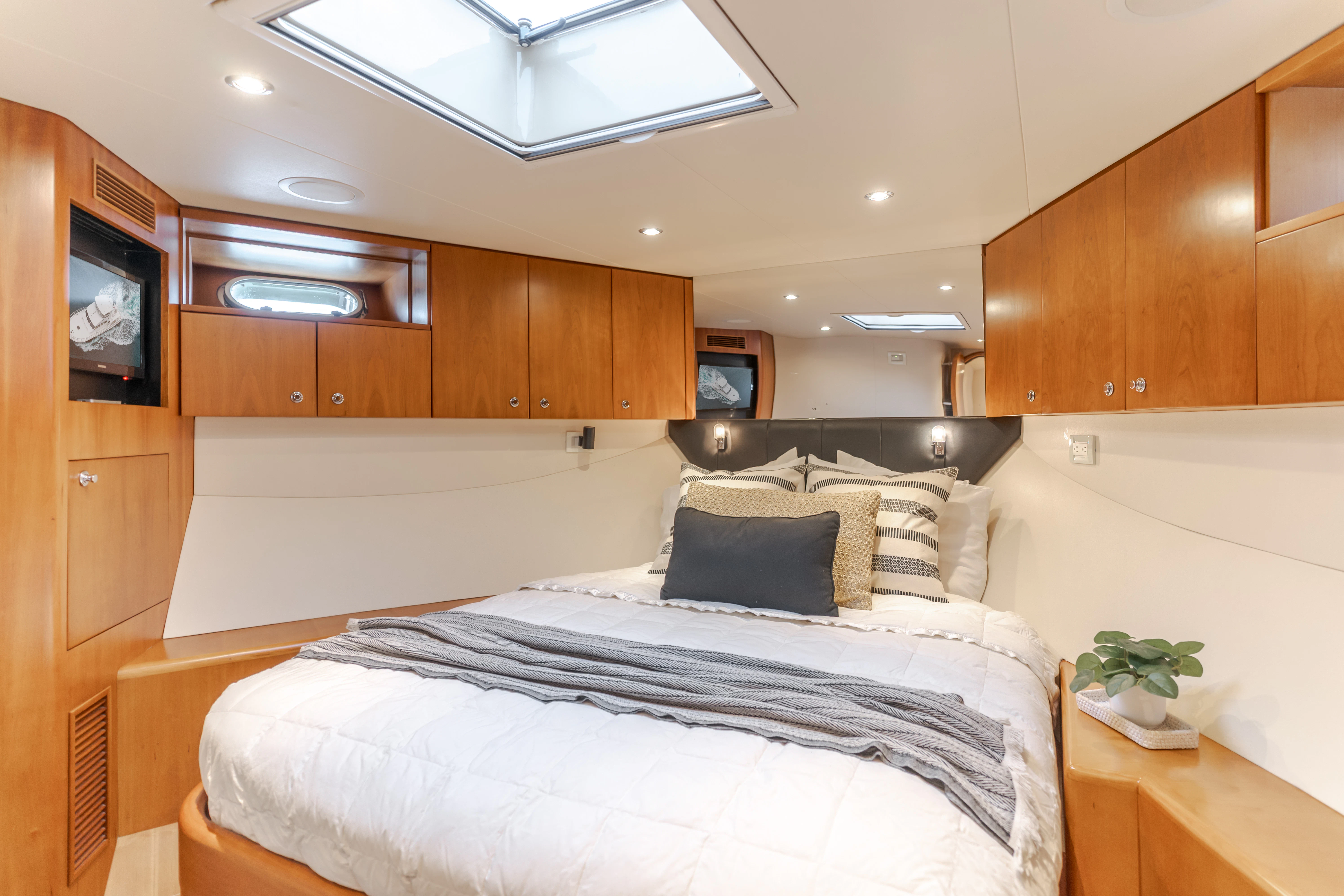 a bedroom with wooden cabinets aboard EASY Yacht for Sale