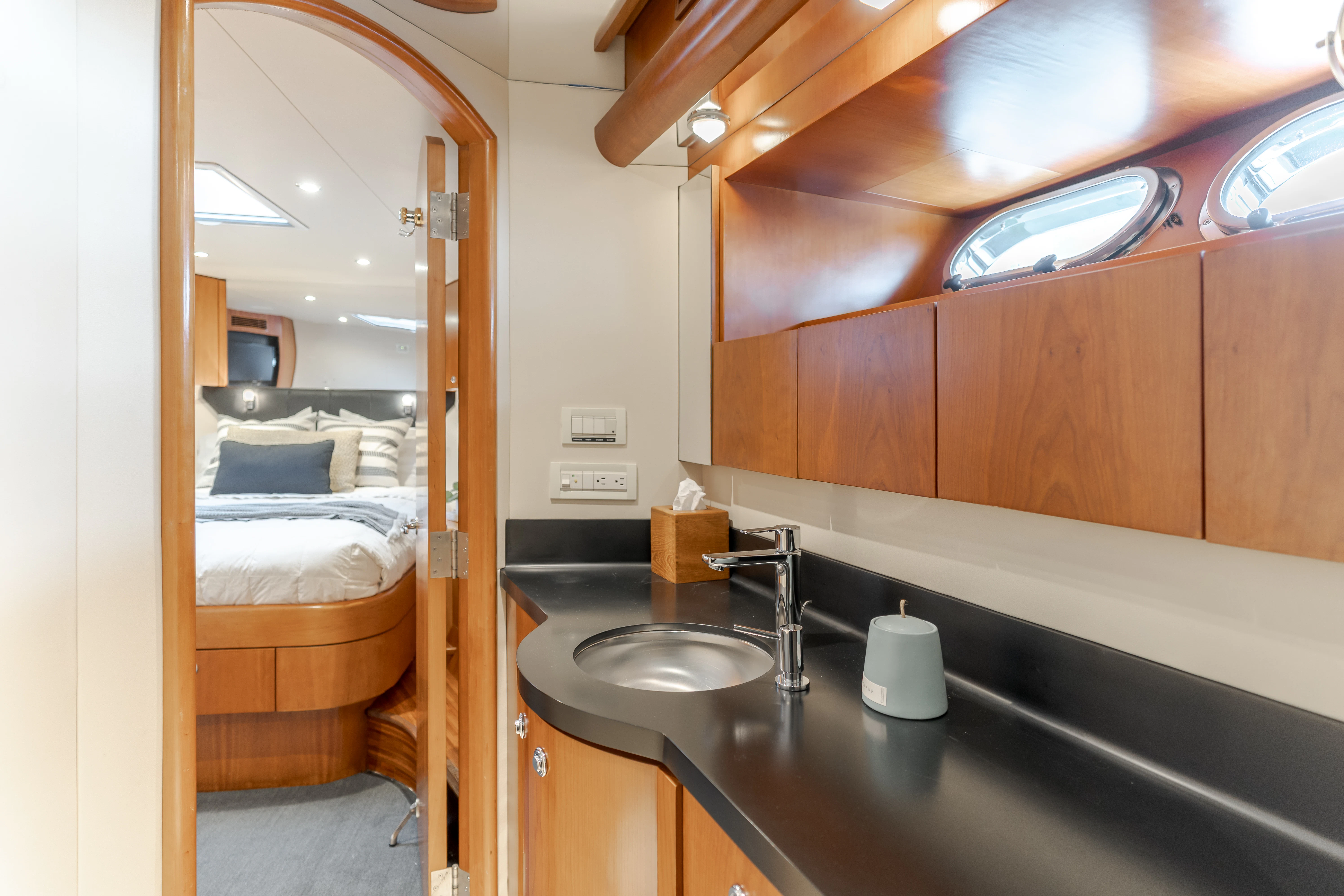 a bathroom with a sink and a bed aboard EASY Yacht for Sale