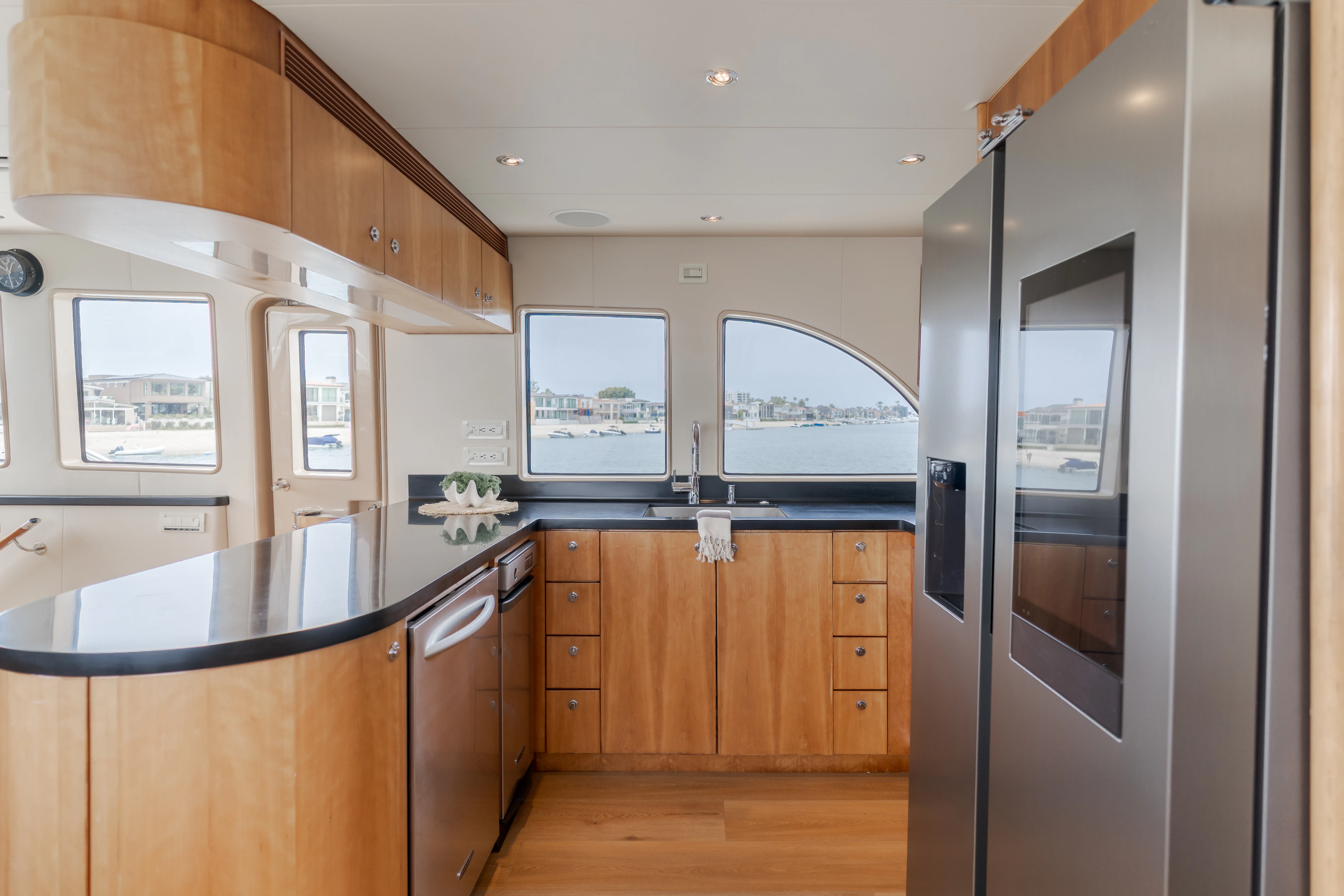 a kitchen with wooden cabinets aboard EASY Yacht for Sale
