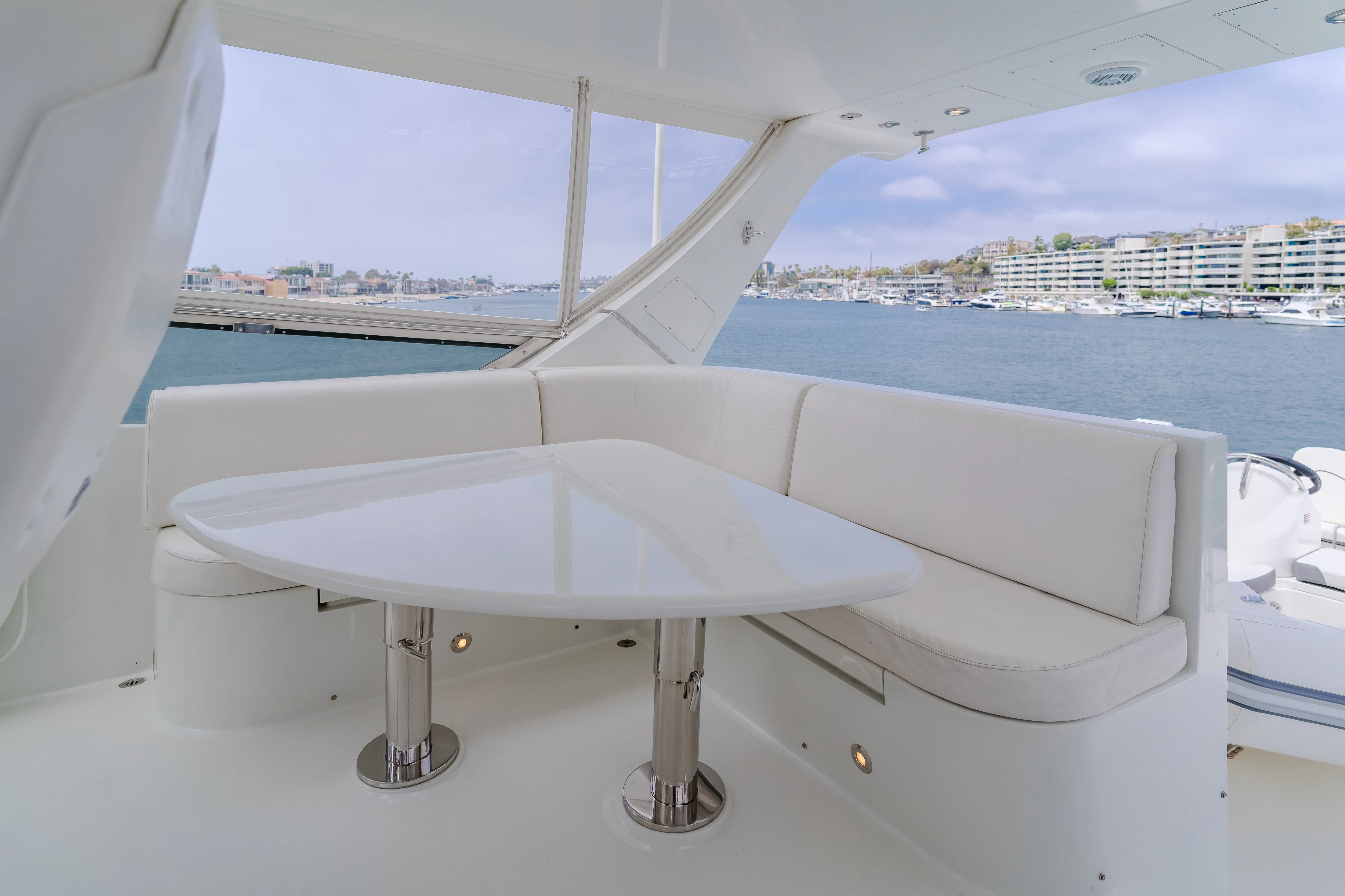 a white bathtub in a room with a window overlooking a city aboard EASY Yacht for Sale