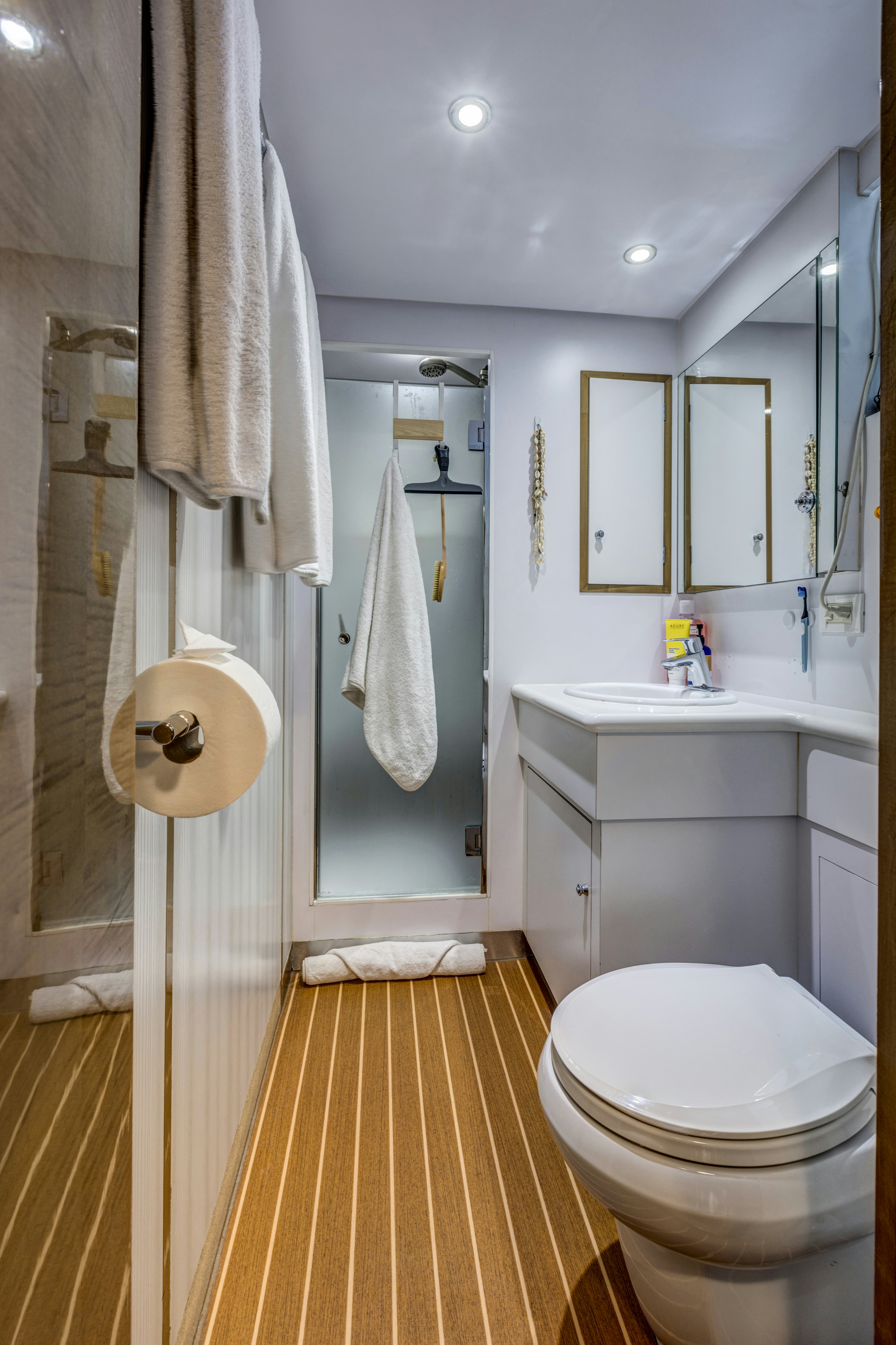 a bathroom with a toilet and sink aboard TRUE NORTH Yacht for Sale