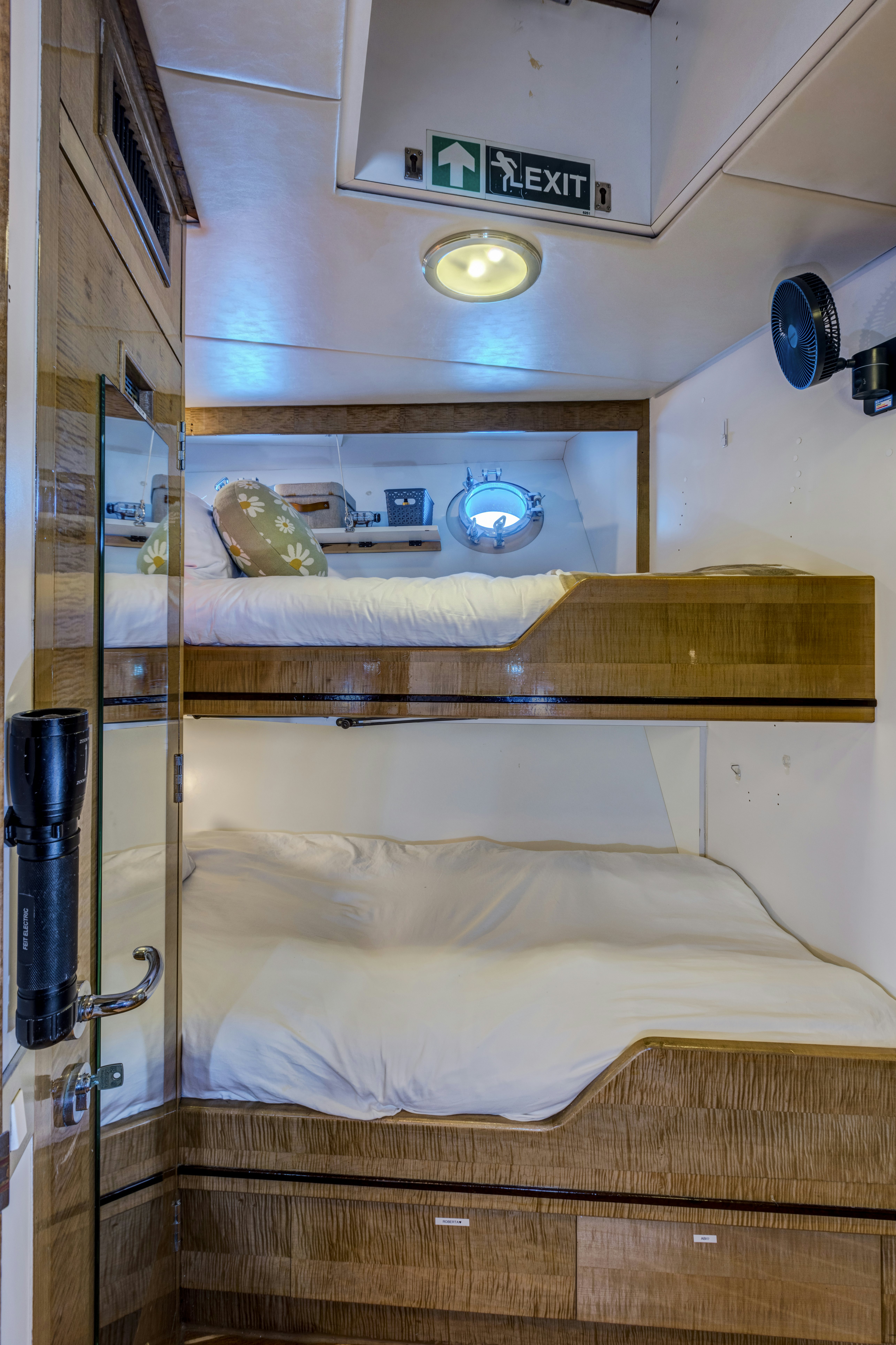 a bunk bed with a light above it aboard TRUE NORTH Yacht for Sale