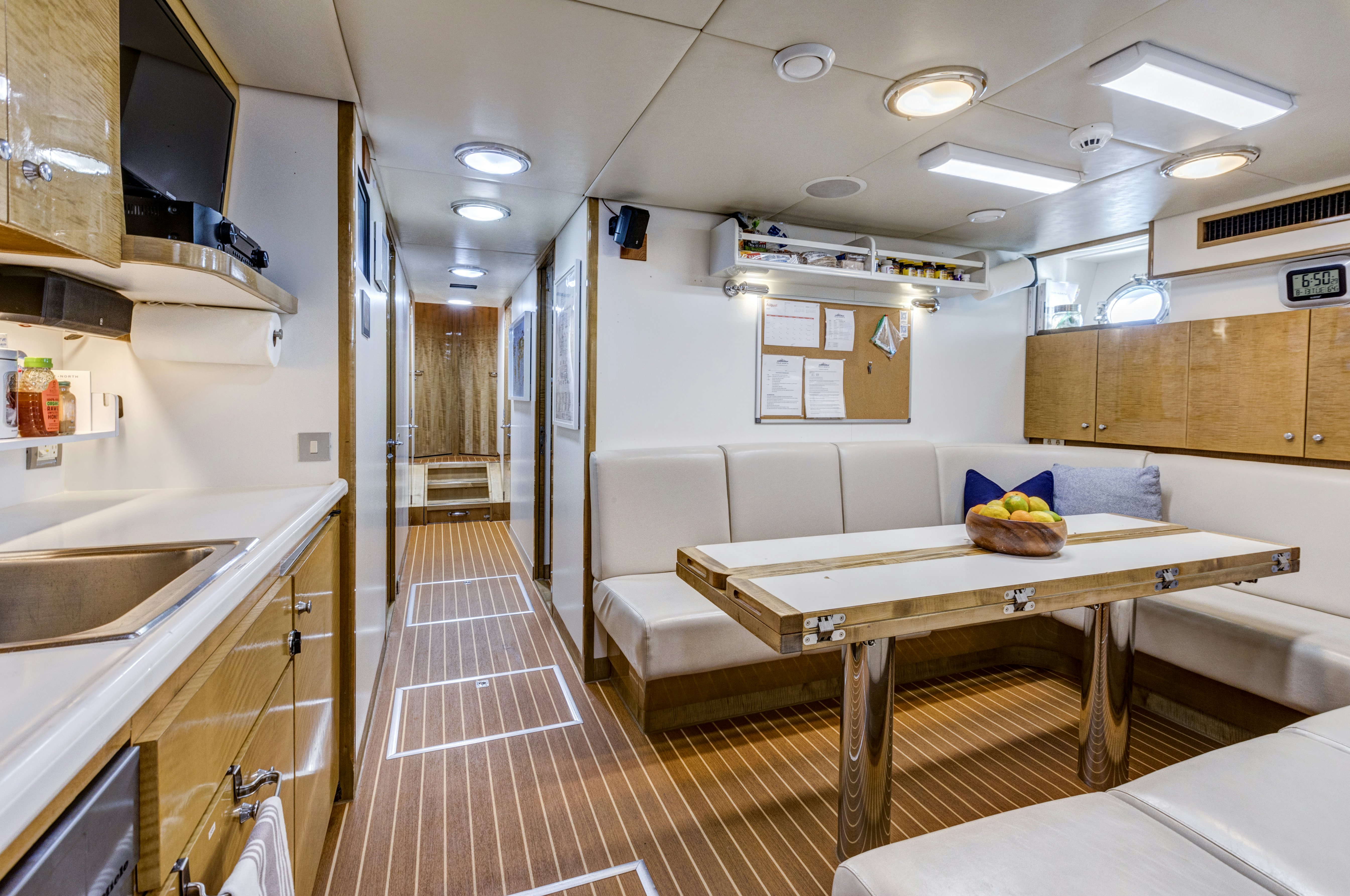 a kitchen with a table and chairs aboard TRUE NORTH Yacht for Sale