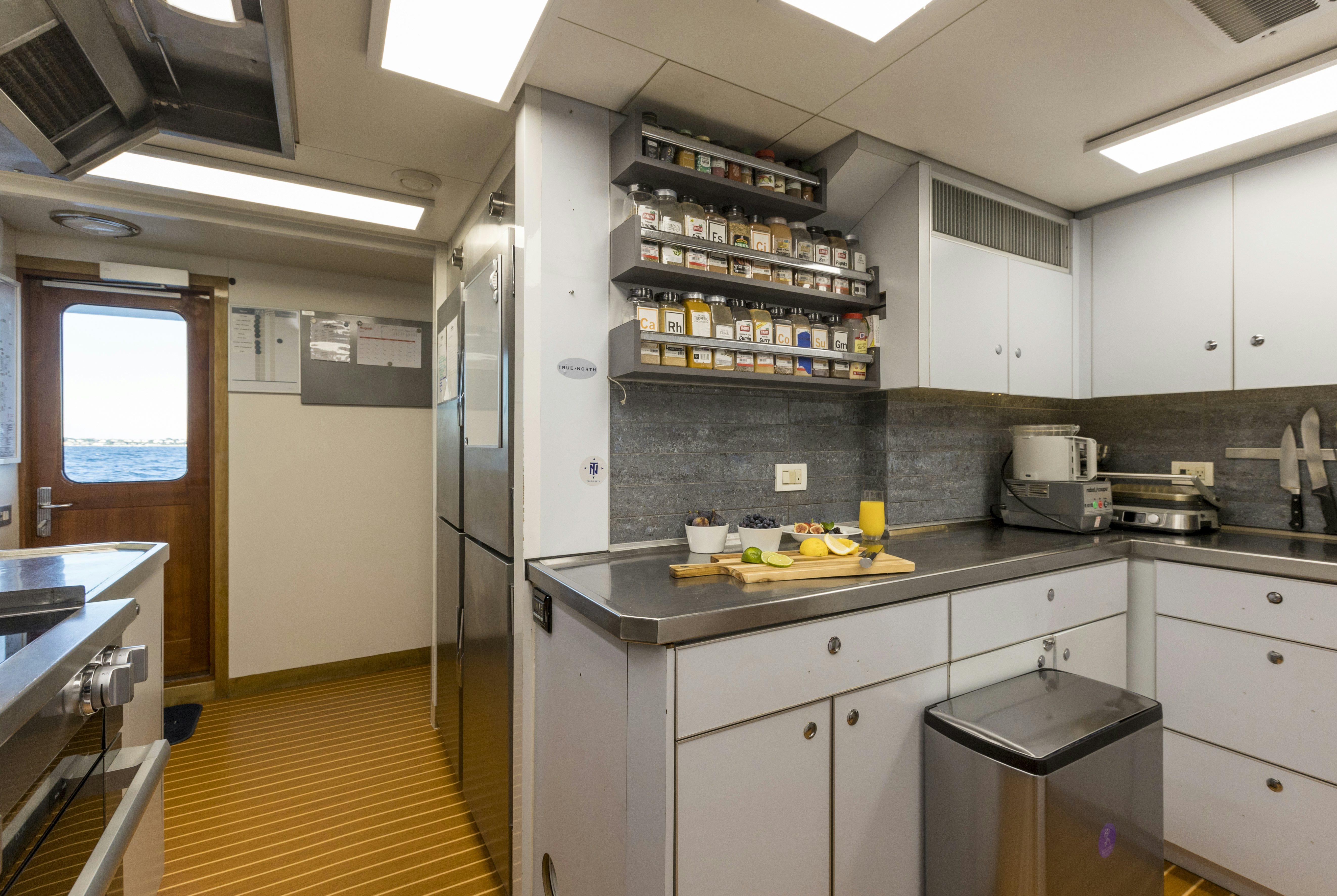 a kitchen with a large island aboard TRUE NORTH Yacht for Sale