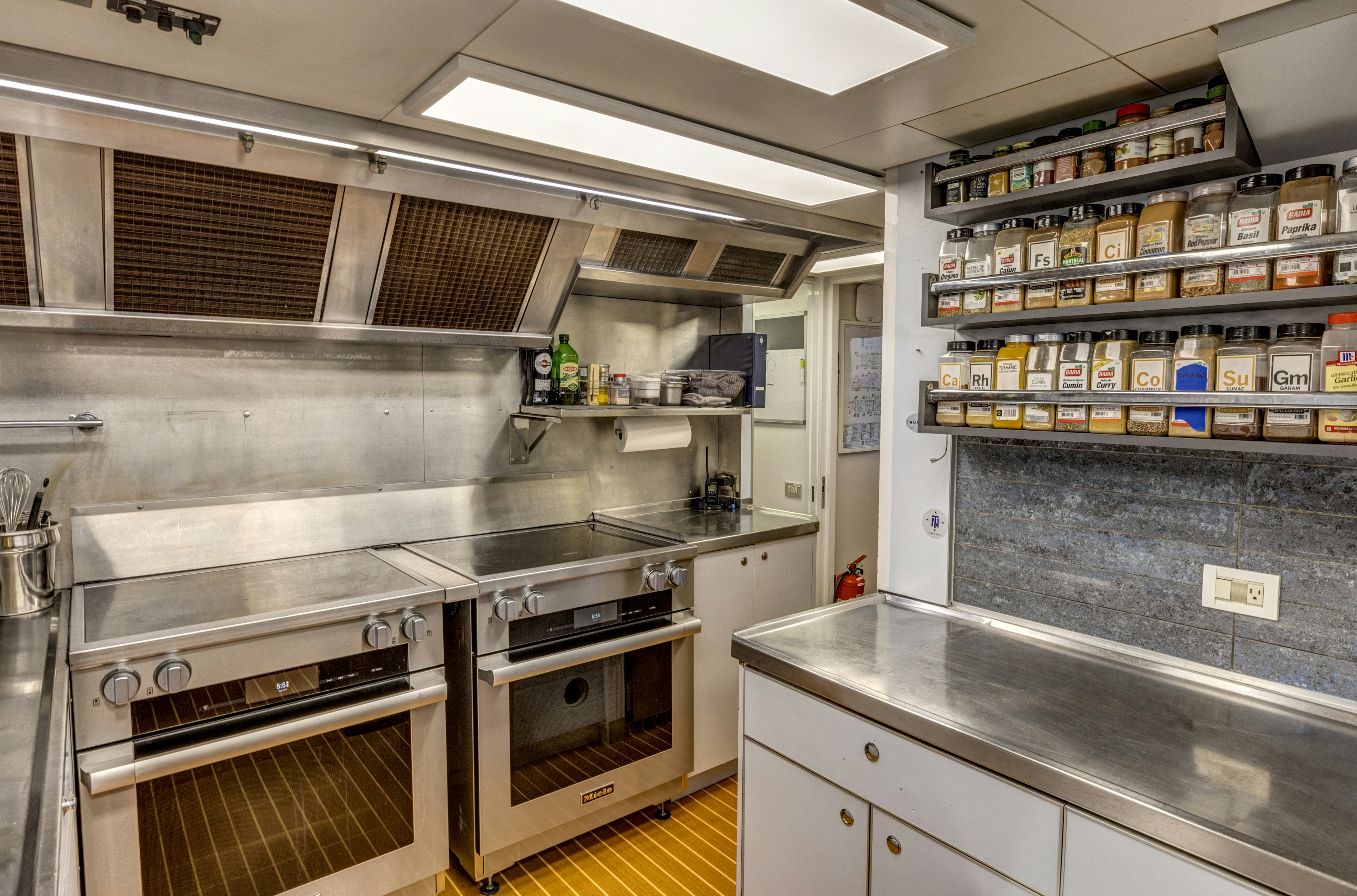 a kitchen with a stove and shelves aboard TRUE NORTH Yacht for Sale