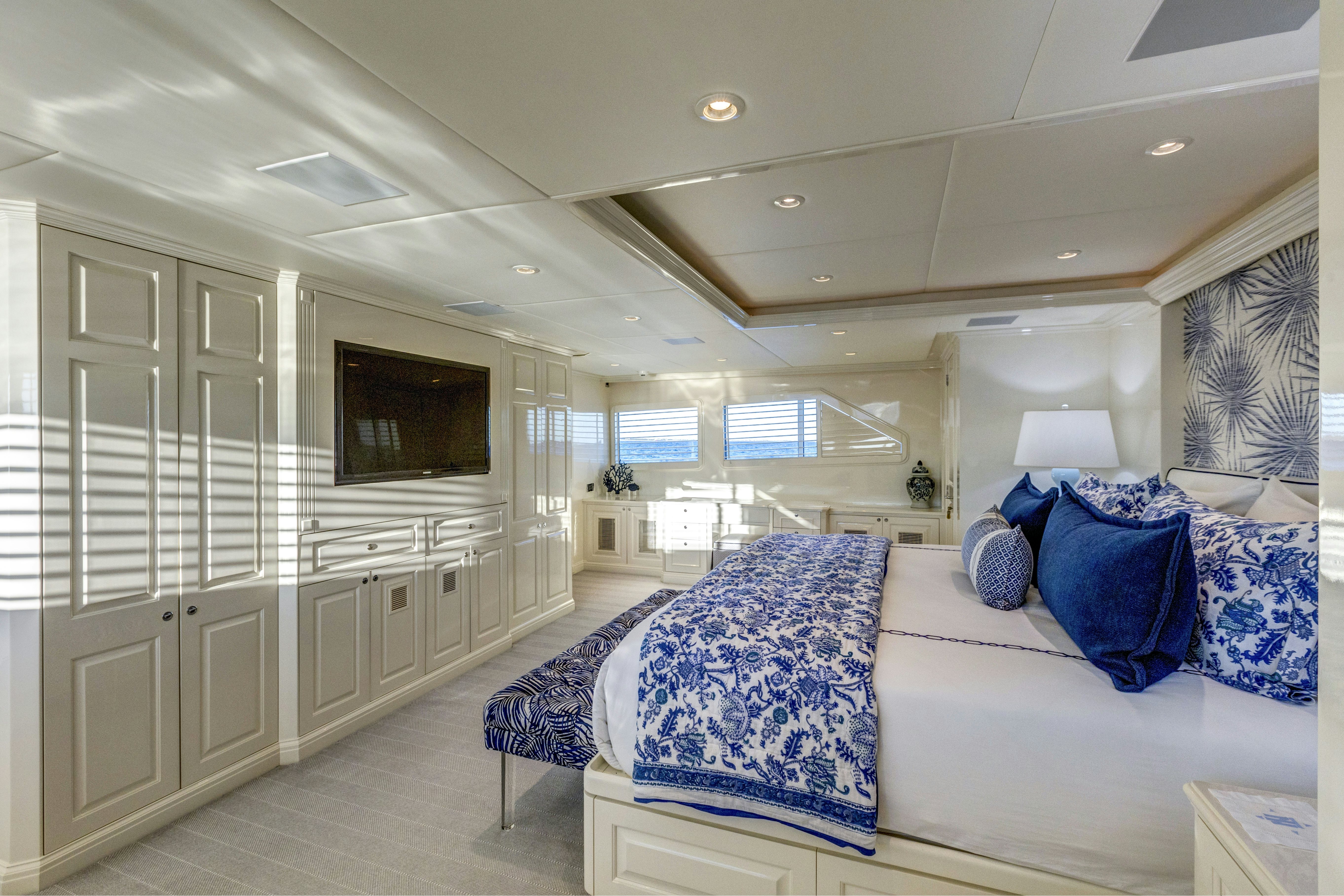 a bedroom with a bed and a television aboard TRUE NORTH Yacht for Sale