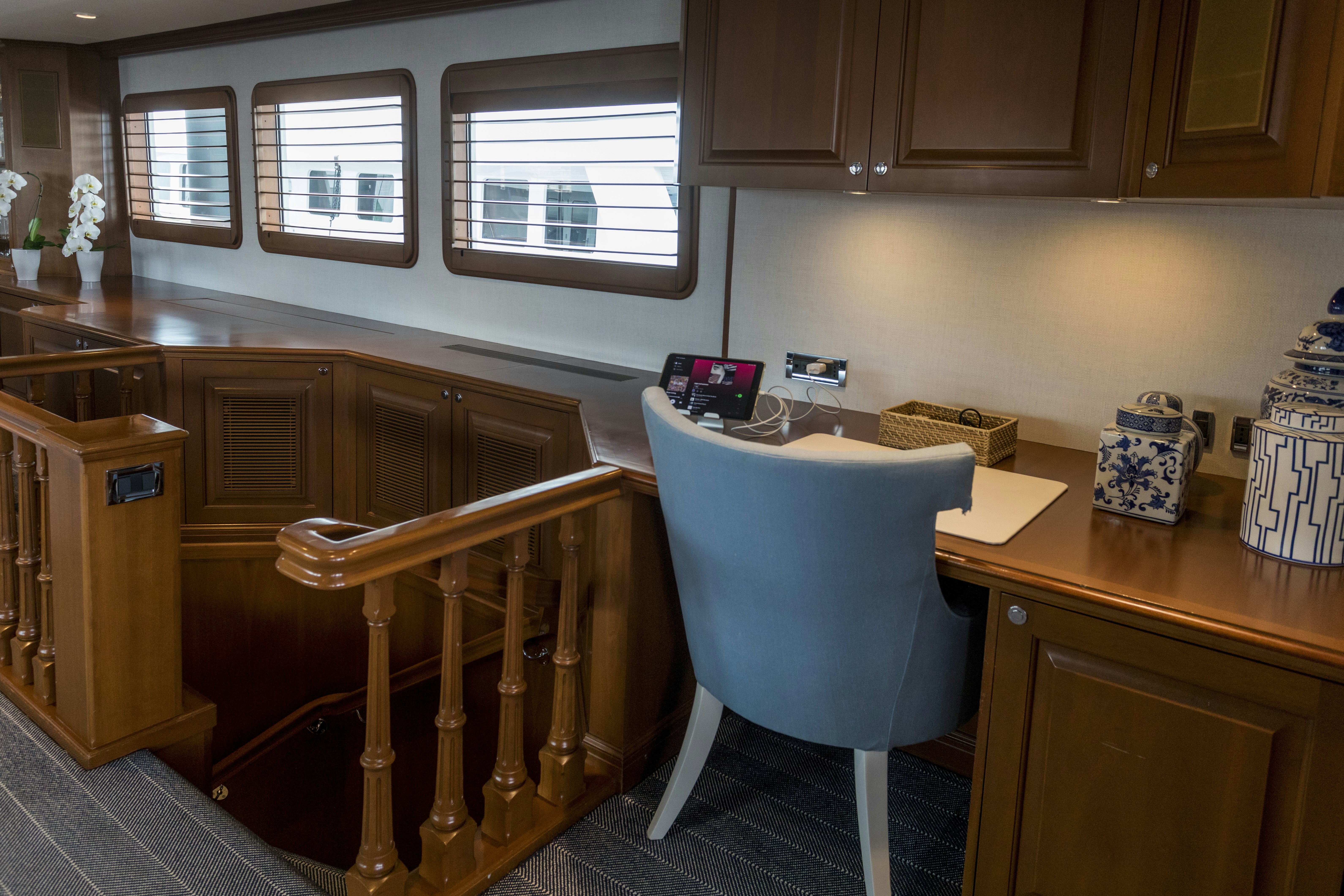 a kitchen with a blue chair aboard TRUE NORTH Yacht for Sale