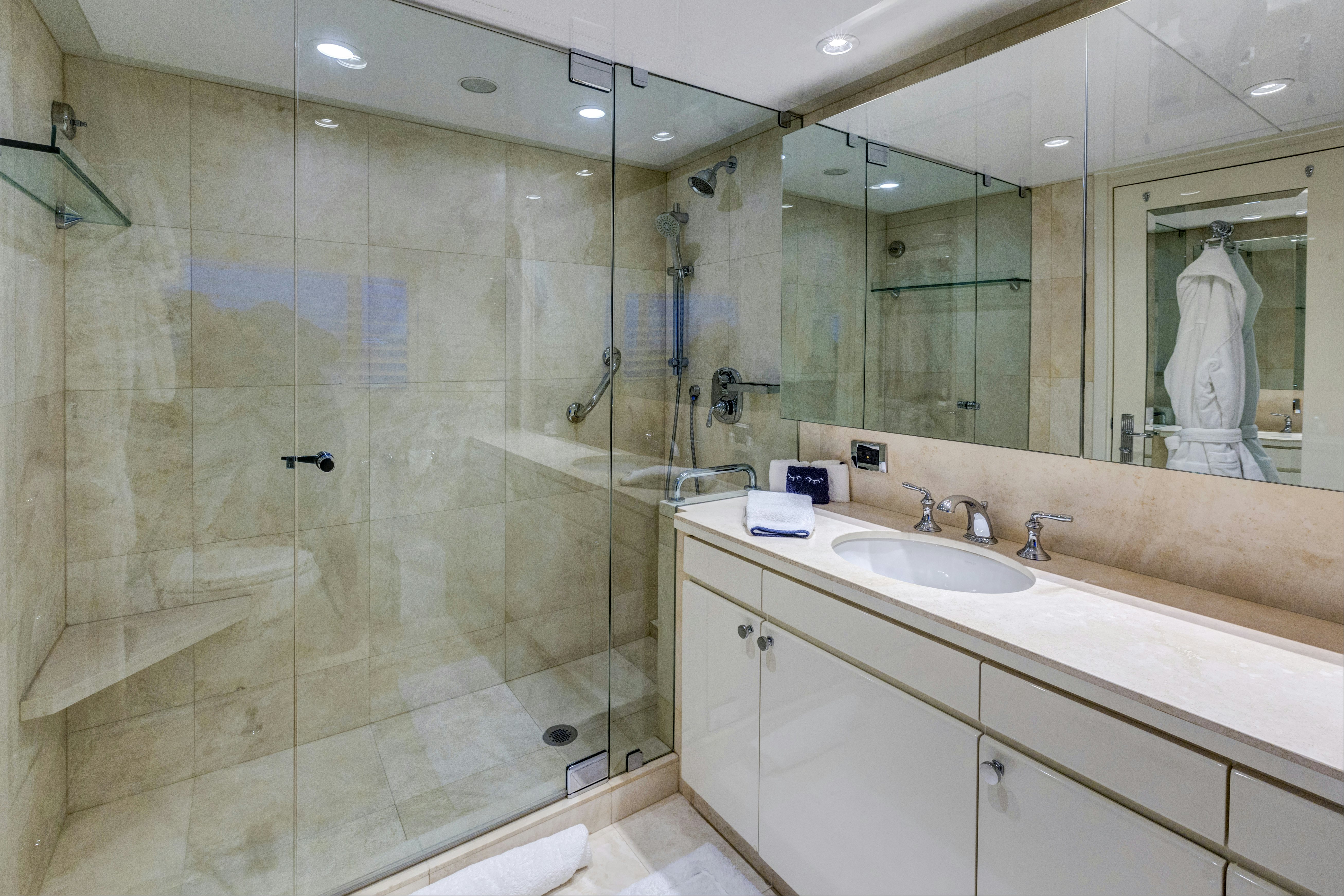 a bathroom with a glass shower aboard TRUE NORTH Yacht for Sale