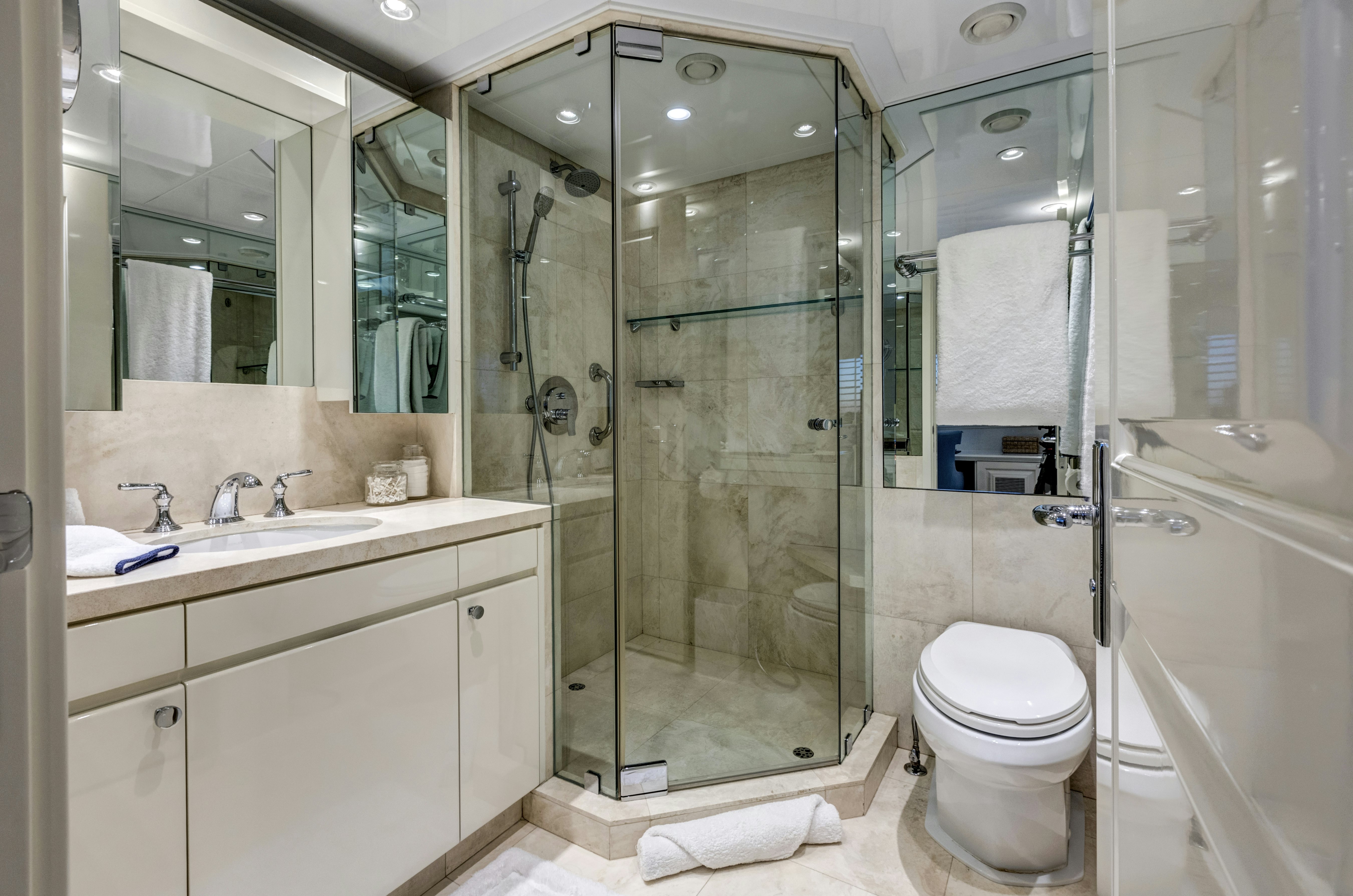 a bathroom with a glass shower aboard TRUE NORTH Yacht for Sale