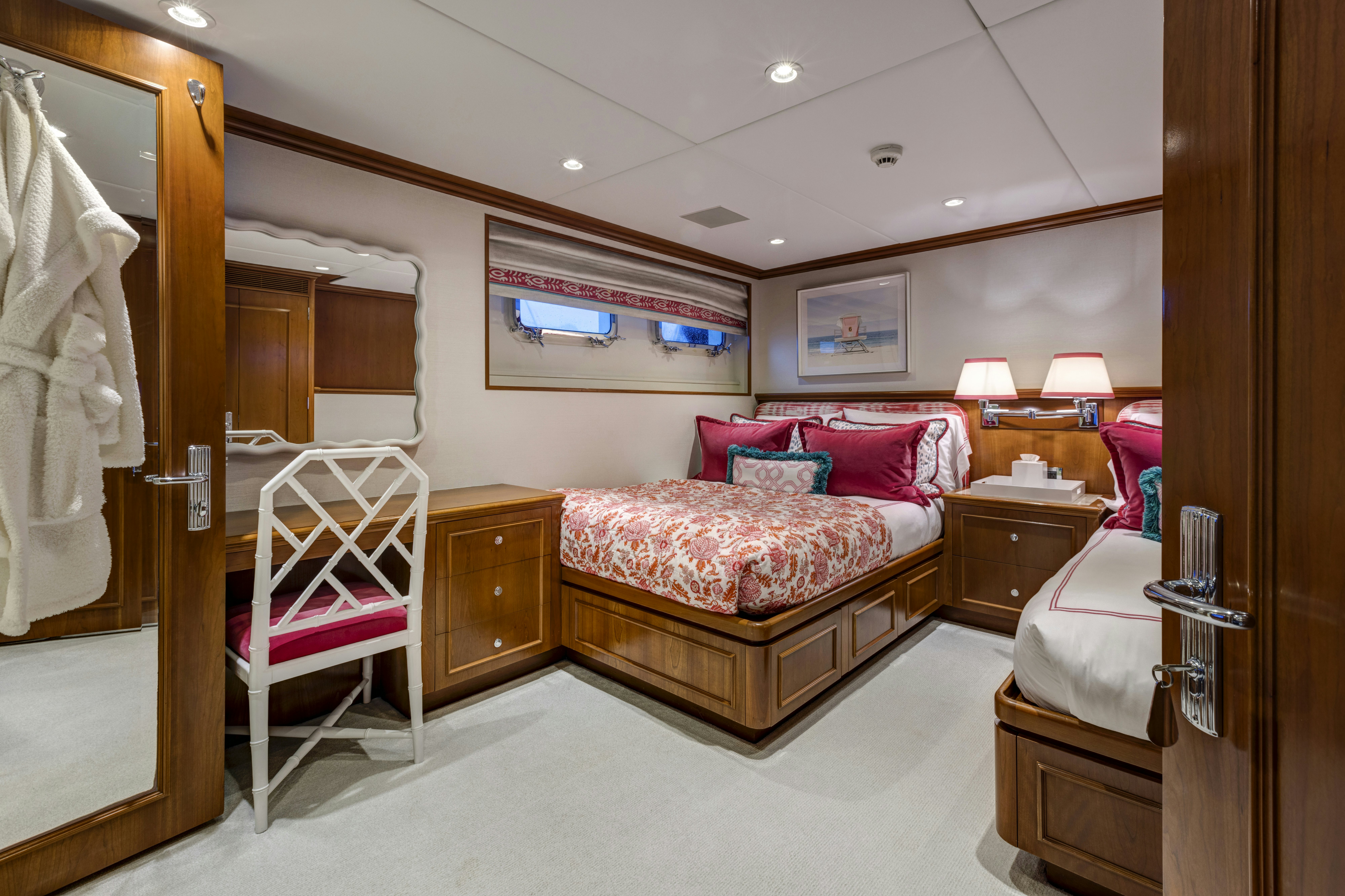 a bedroom with a bed and a chair aboard TRUE NORTH Yacht for Sale
