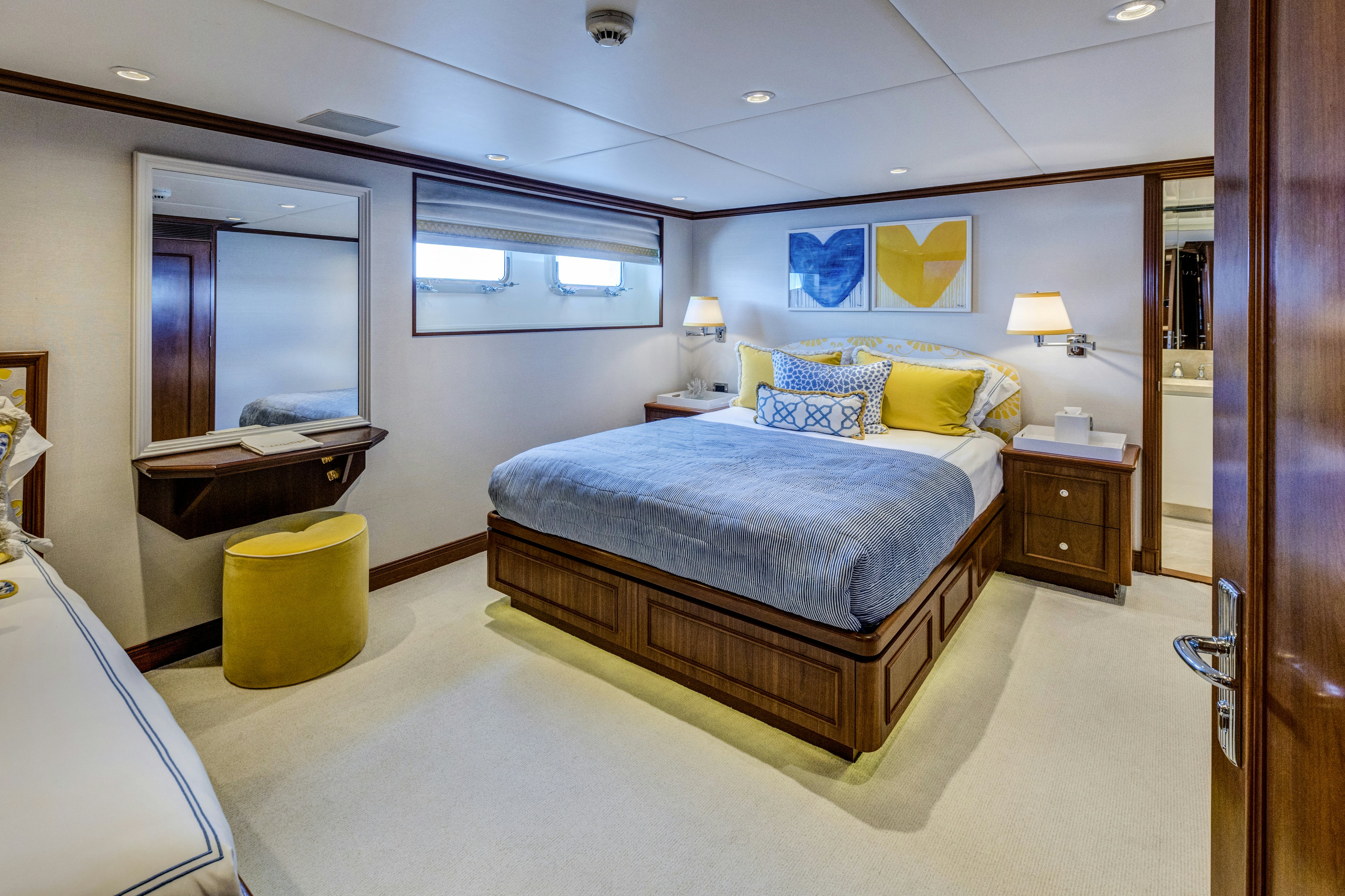 a bedroom with a bed and a desk aboard TRUE NORTH Yacht for Sale