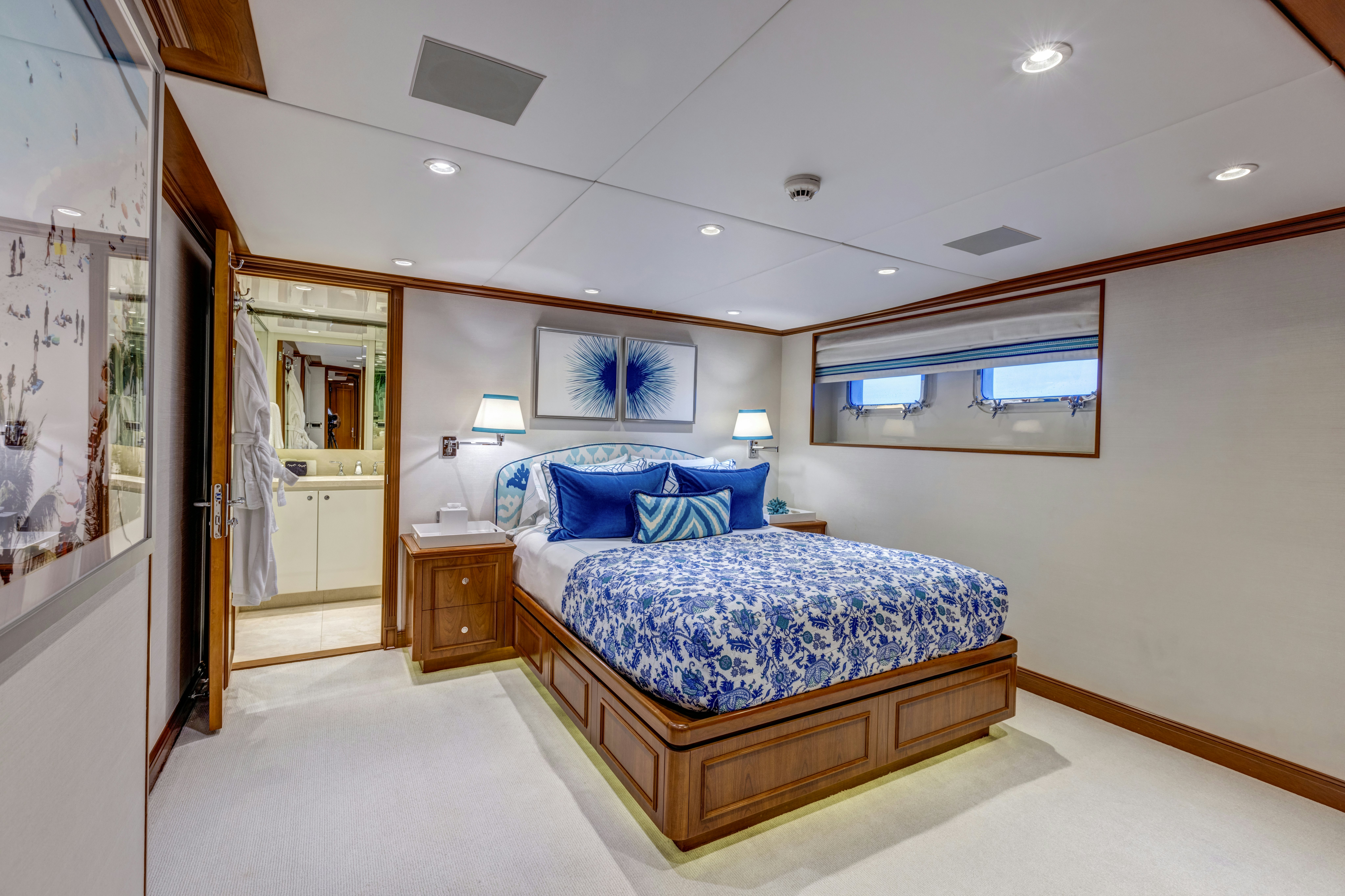 a bedroom with a bed and a lamp aboard TRUE NORTH Yacht for Sale