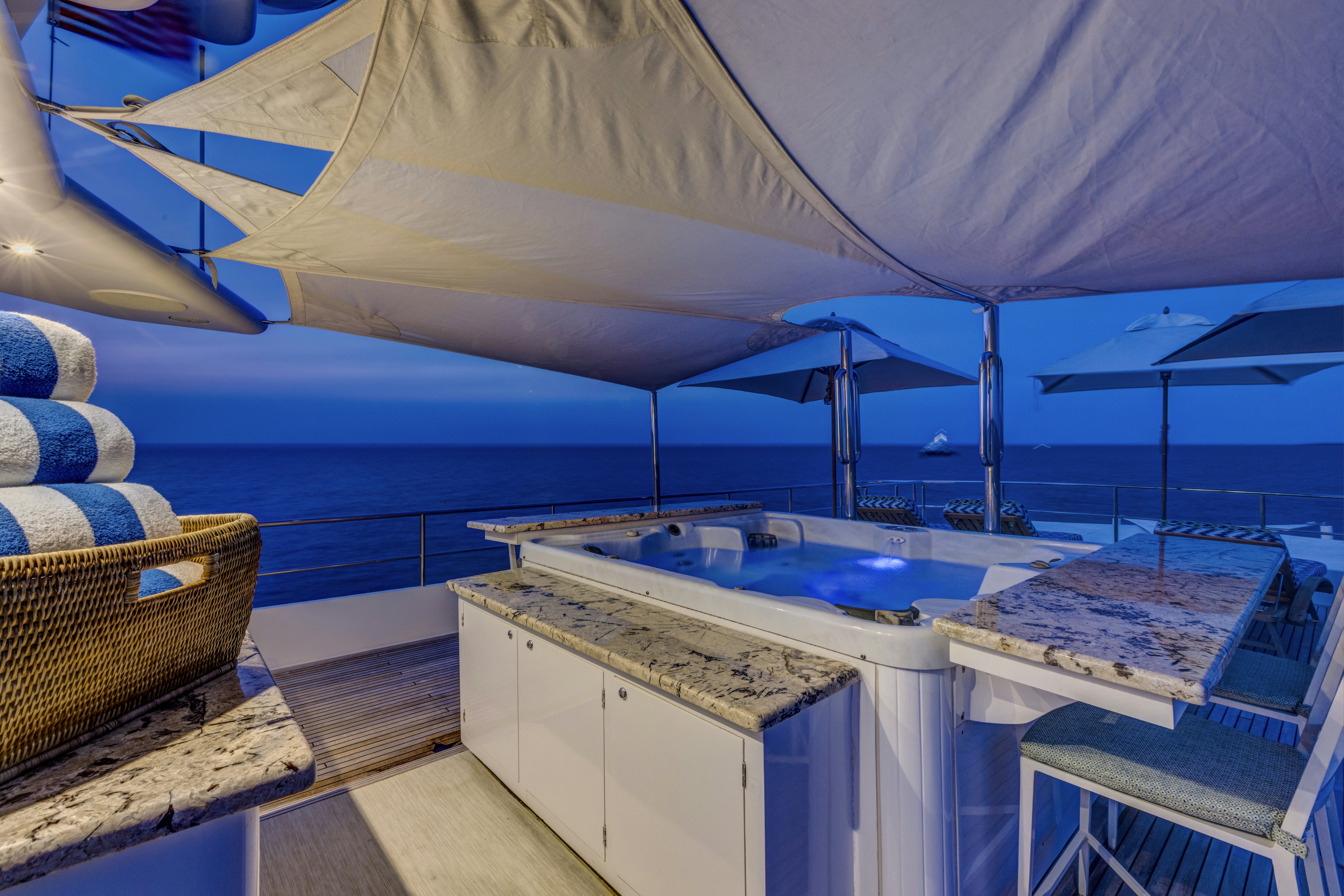 a large white tent with a large pool and a picnic table aboard TRUE NORTH Yacht for Sale