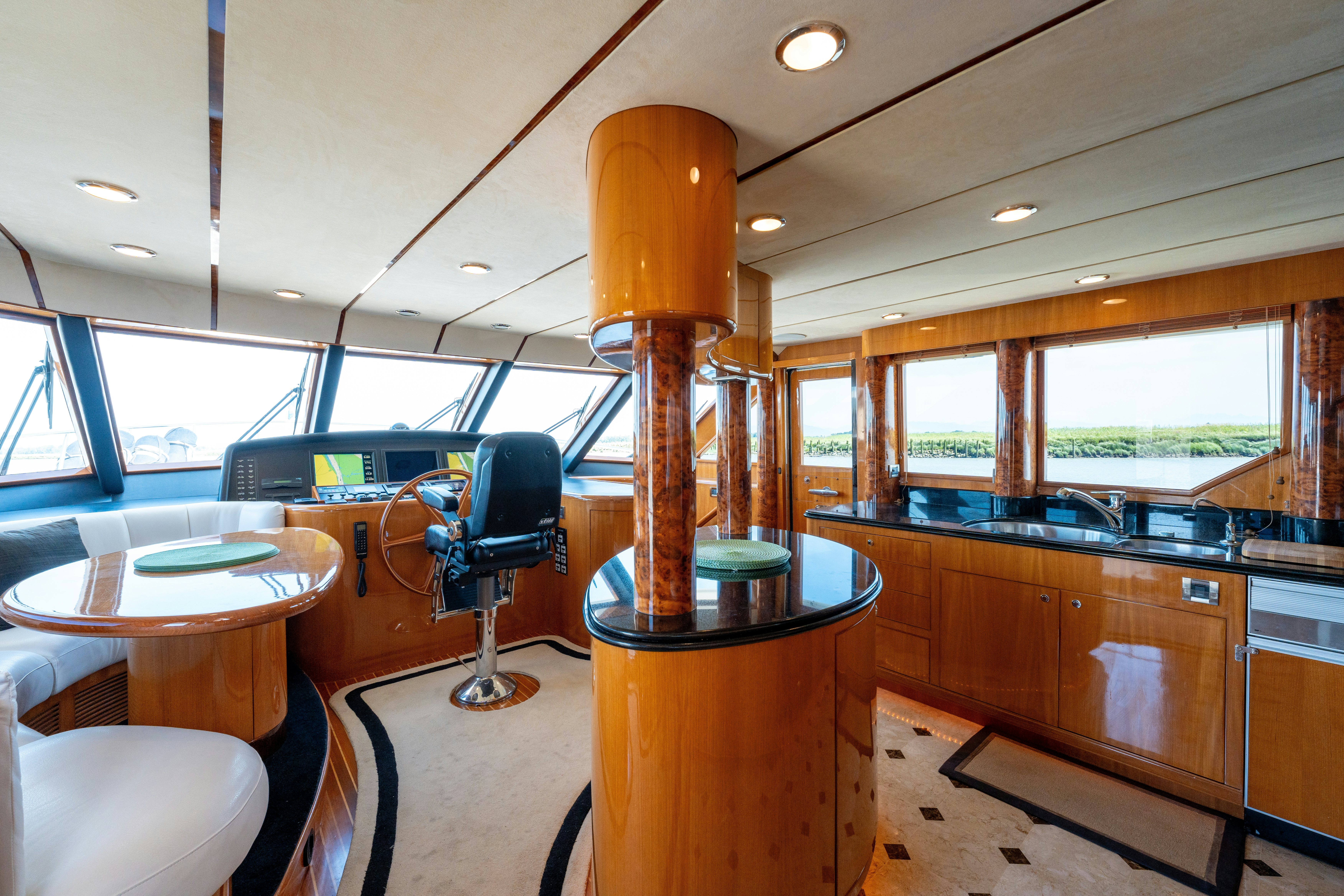 a large kitchen with a large glass table and chairs aboard MEMORY BANK Yacht for Sale