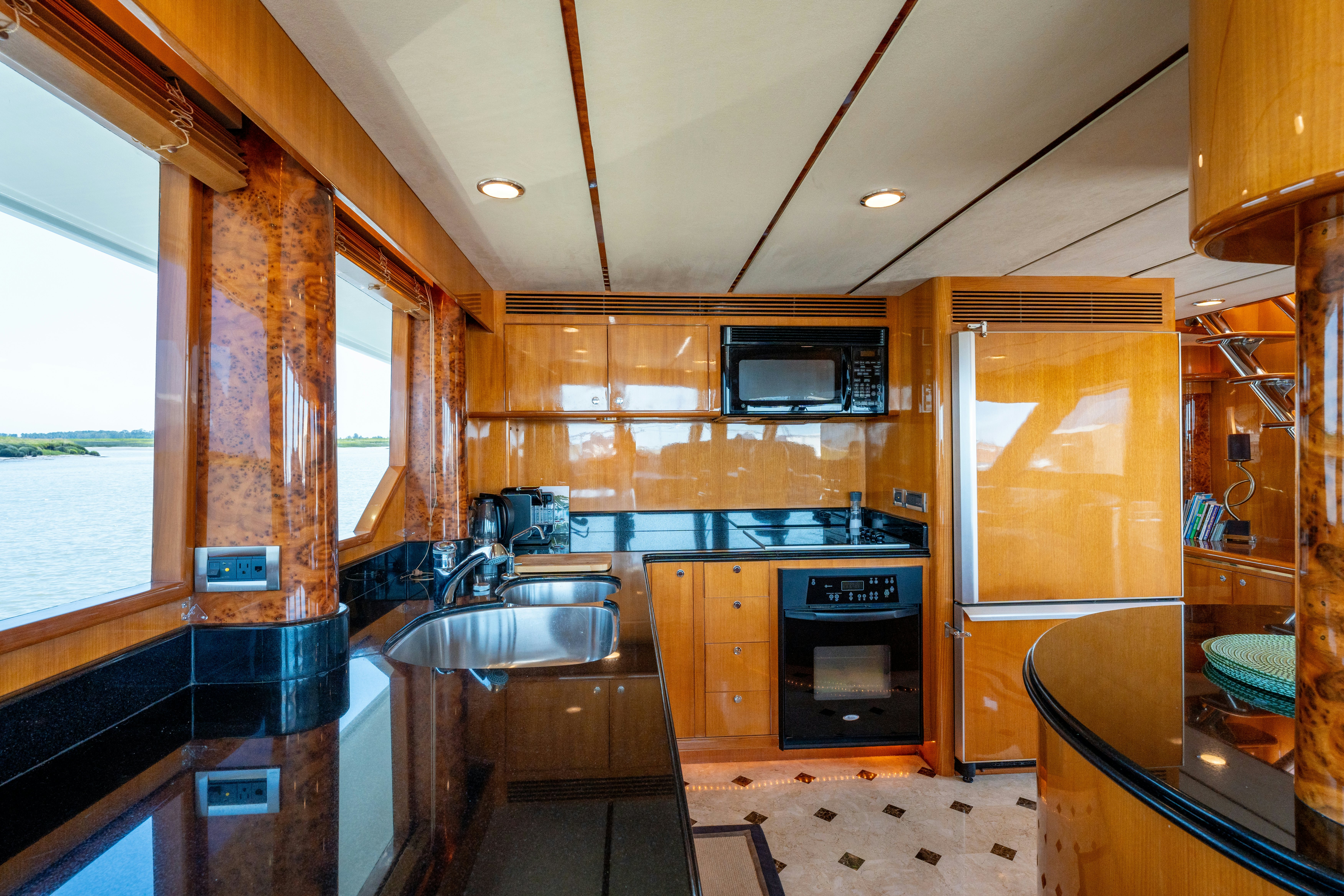 a kitchen with wooden cabinets aboard MEMORY BANK Yacht for Sale