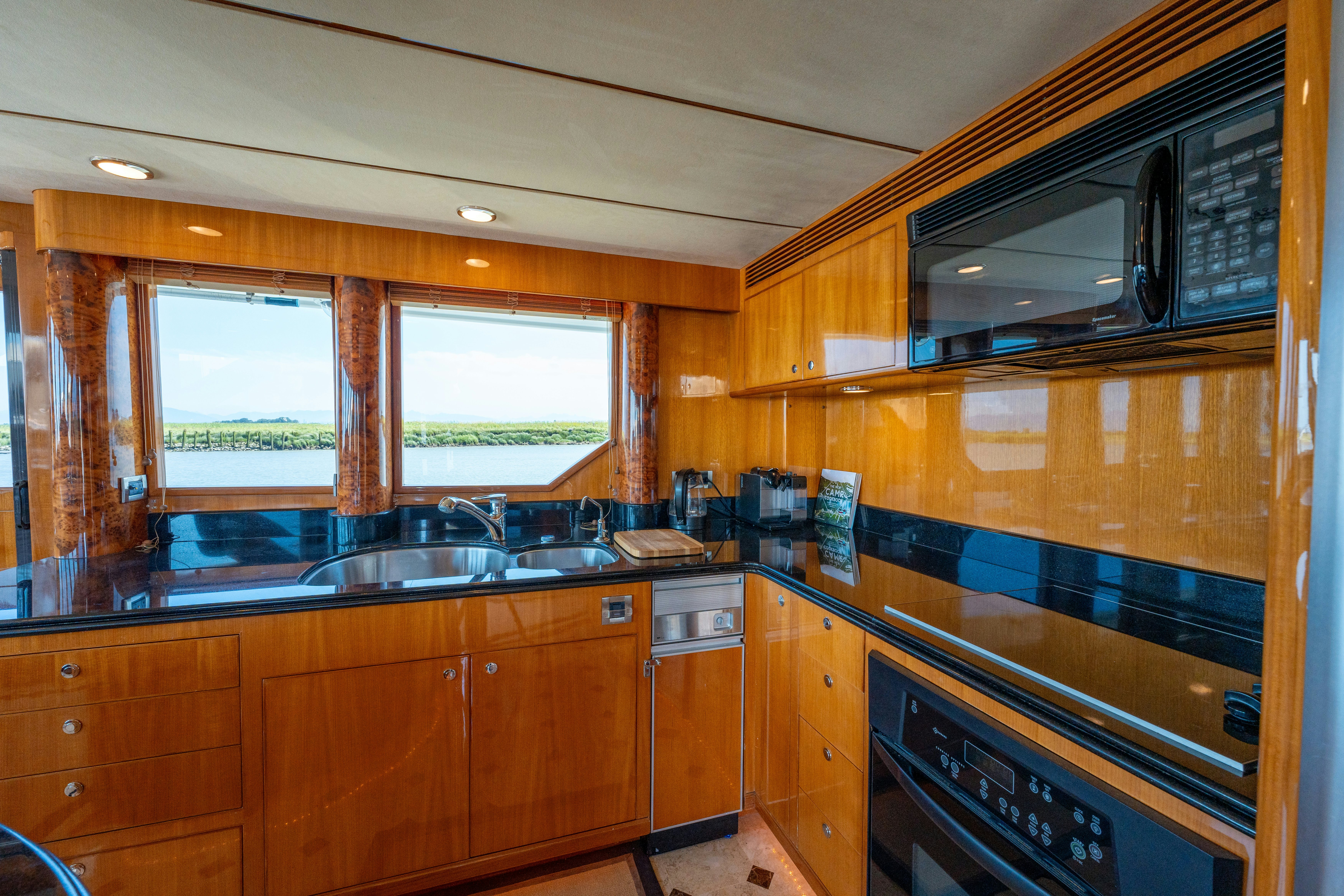 a kitchen with wooden cabinets aboard MEMORY BANK Yacht for Sale