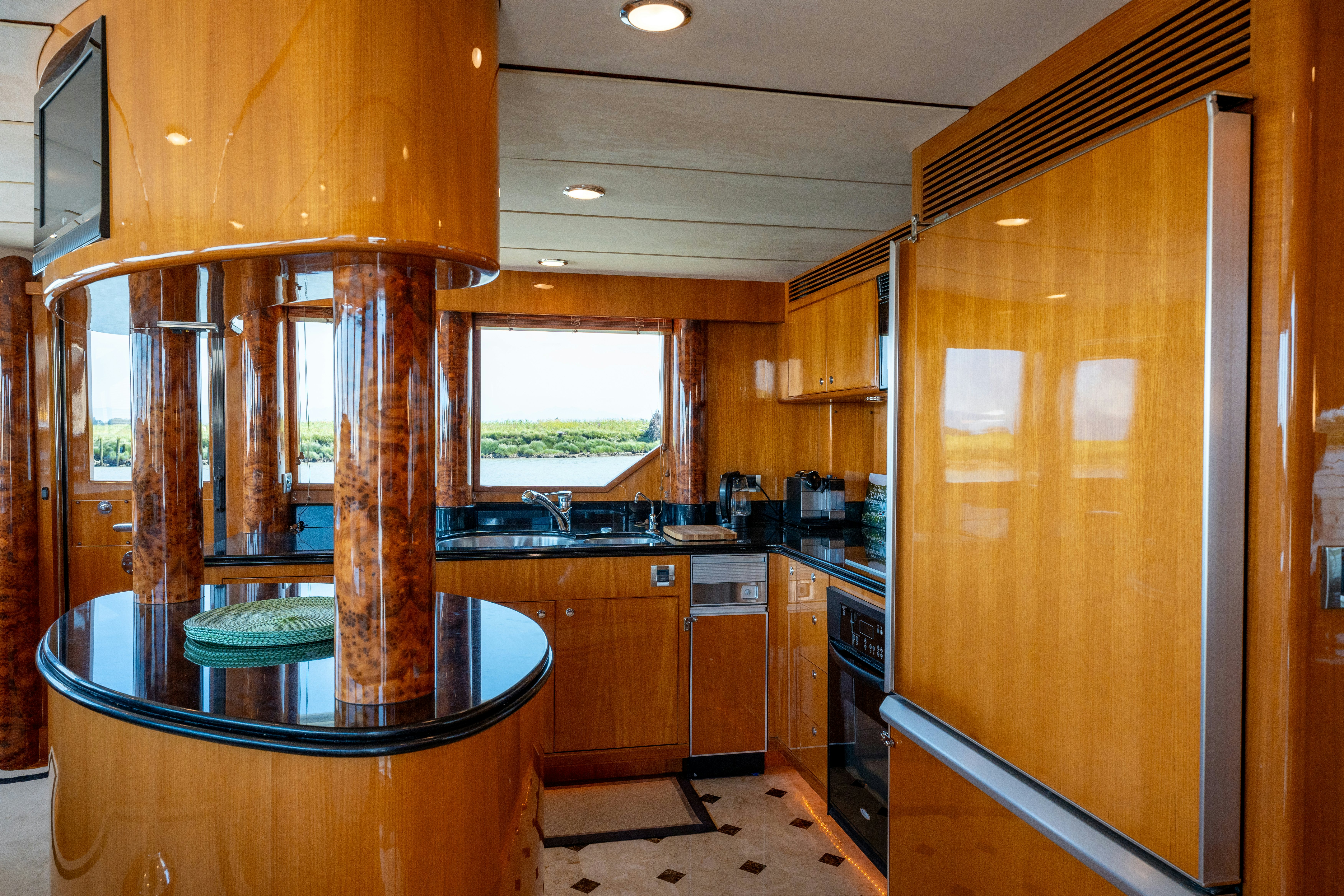 a kitchen with wooden cabinets aboard MEMORY BANK Yacht for Sale