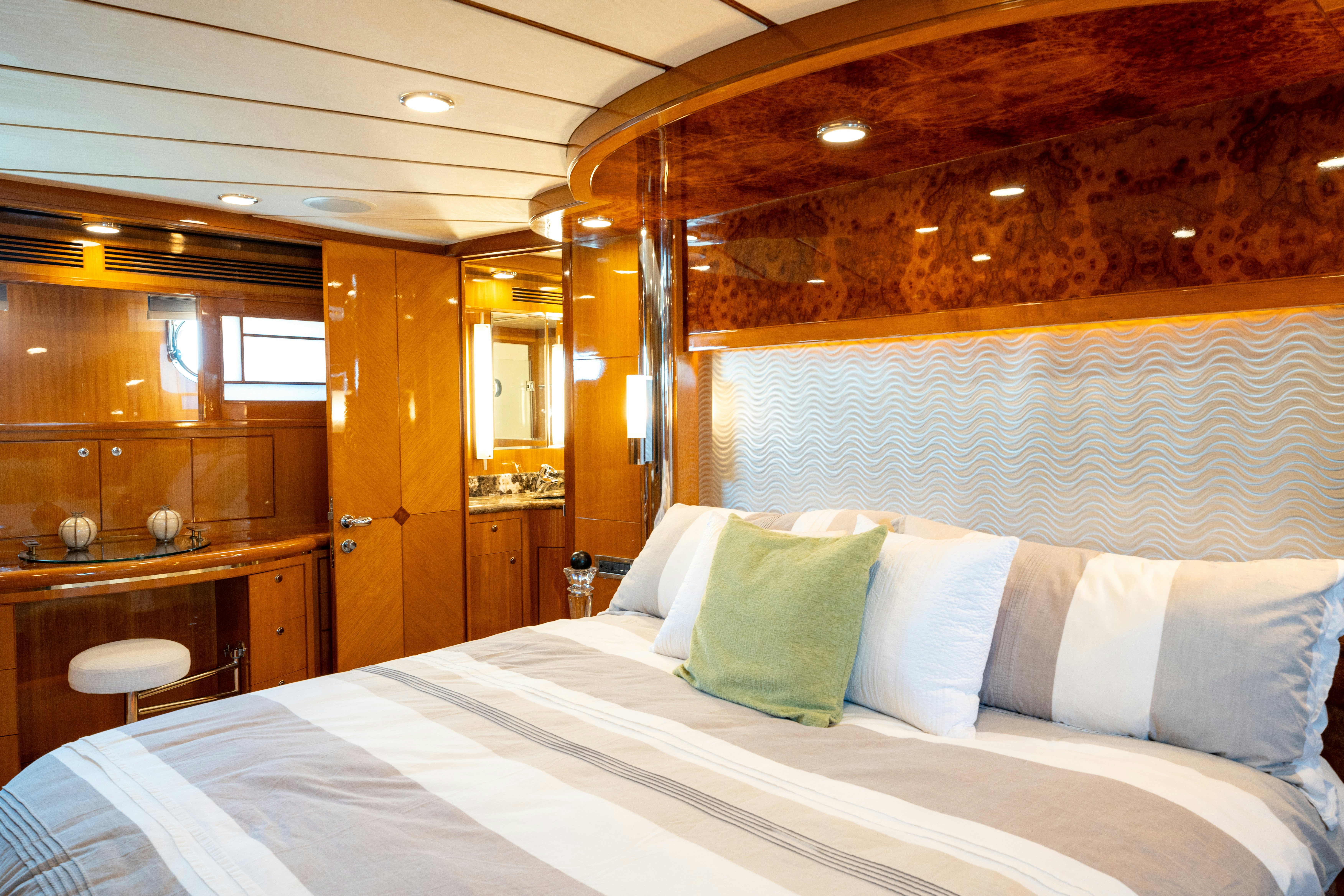 a bed with white sheets and pillows aboard MEMORY BANK Yacht for Sale