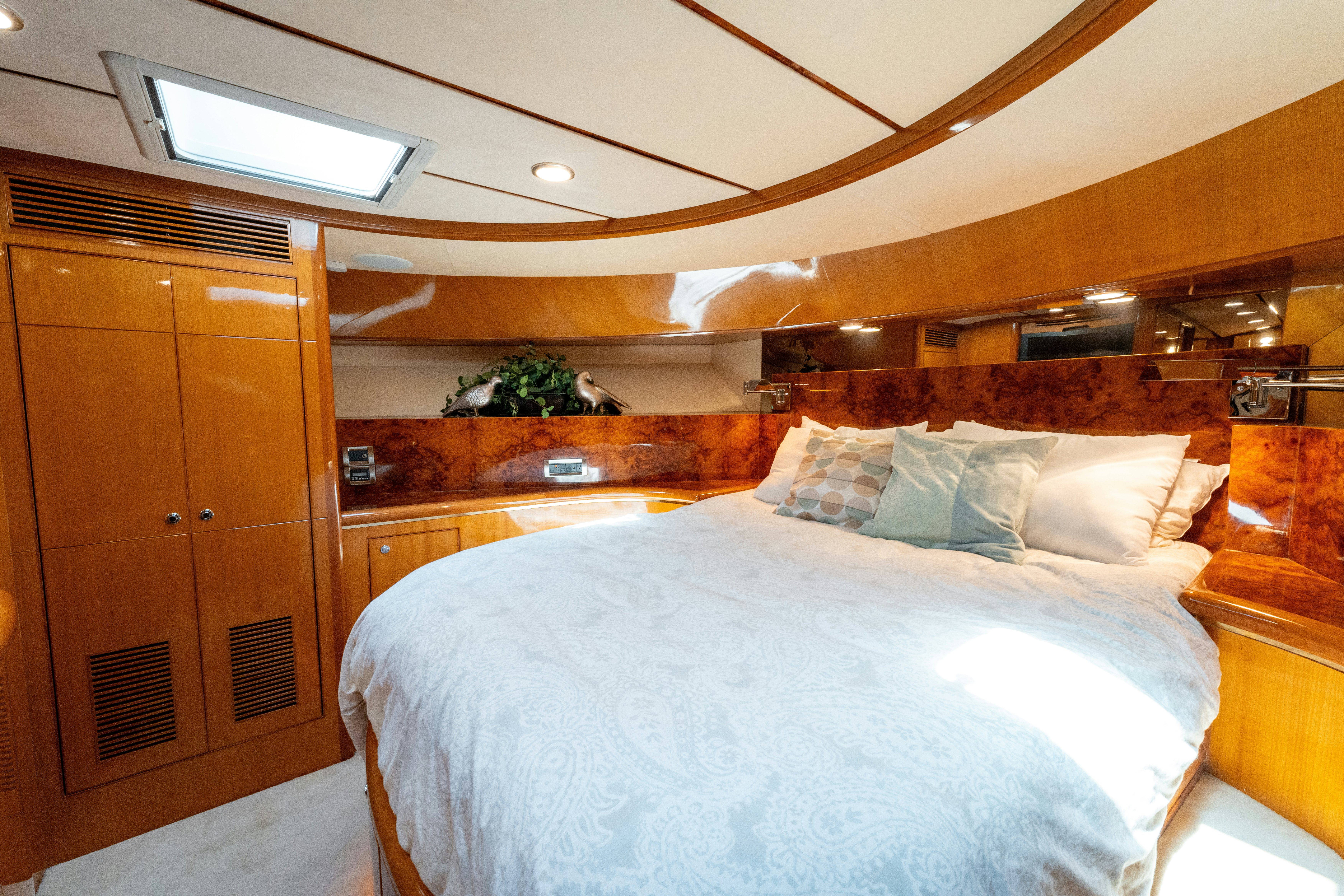 a room with a bed and a wood cabinet aboard MEMORY BANK Yacht for Sale