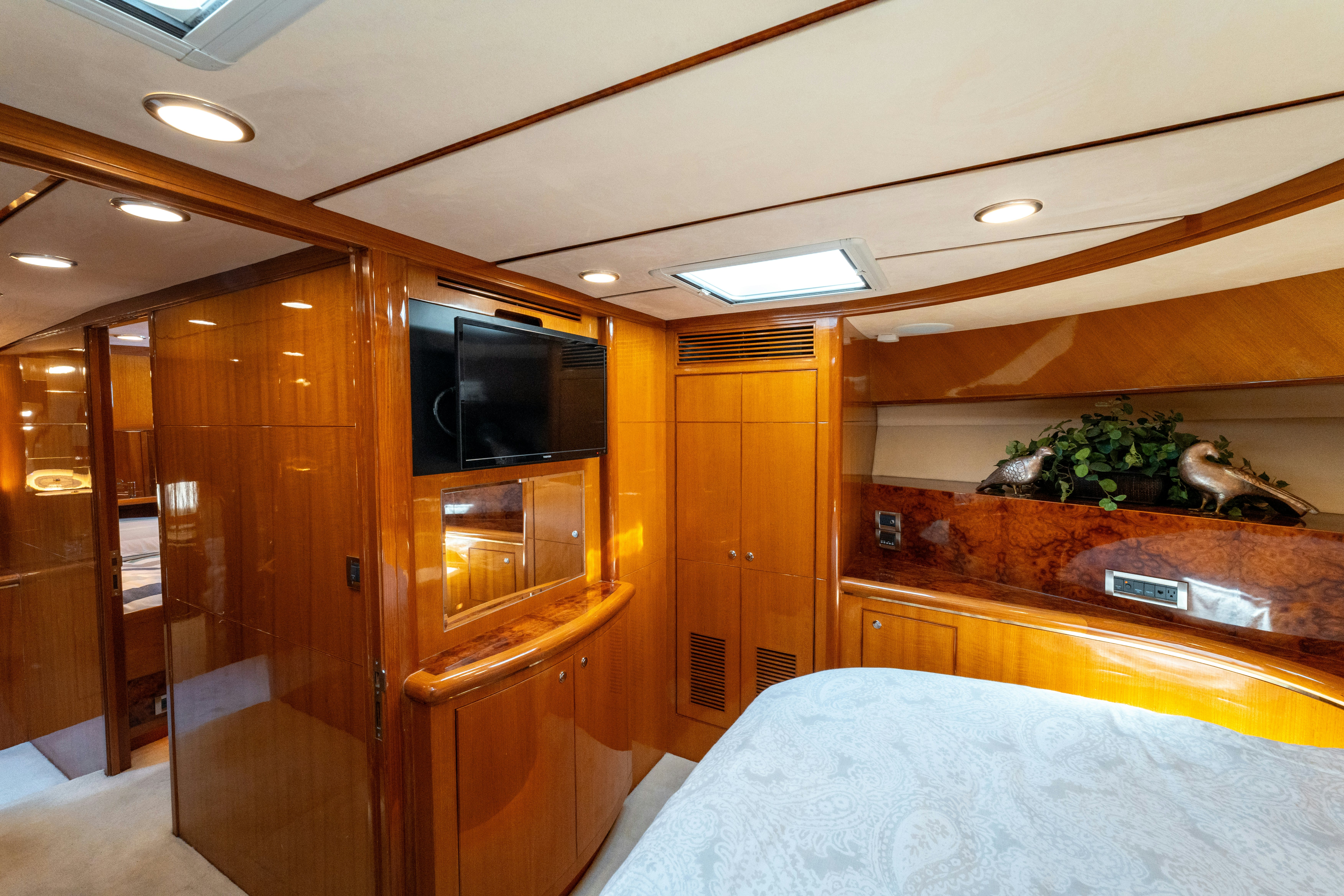 a room with a bed and a television aboard MEMORY BANK Yacht for Sale