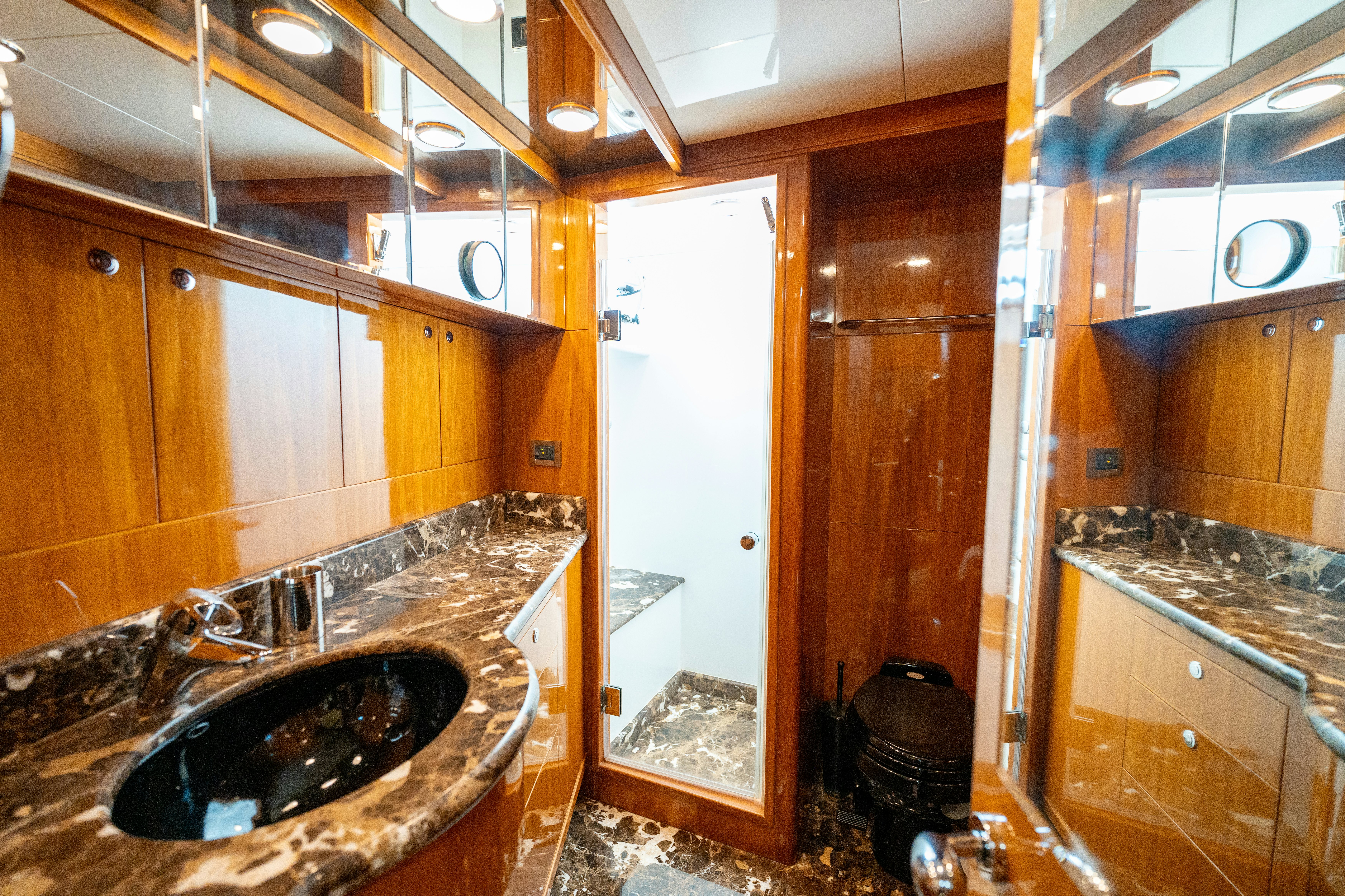 a bathroom with a sink and a large mirror aboard MEMORY BANK Yacht for Sale