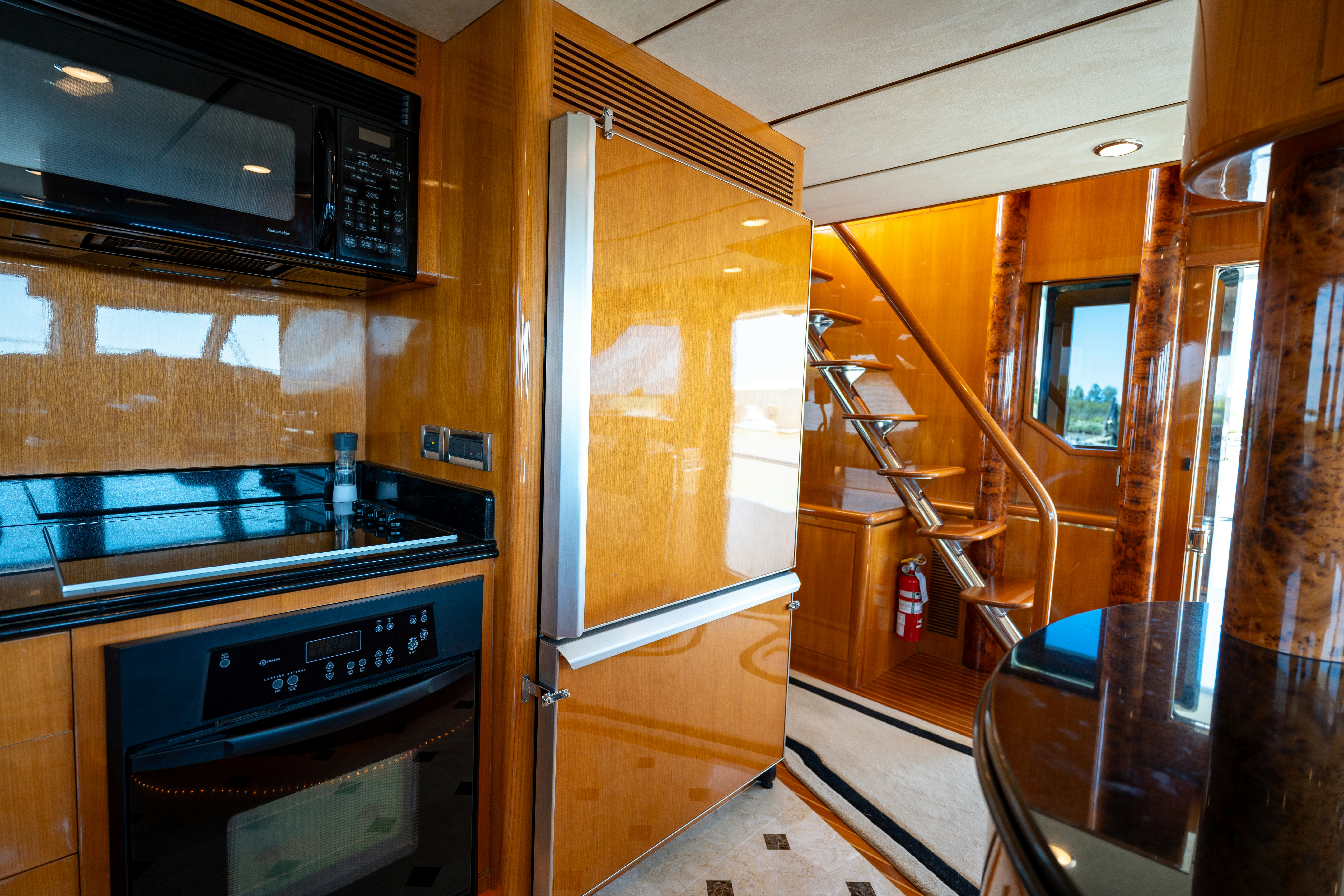 a kitchen with wooden cabinets aboard MEMORY BANK Yacht for Sale