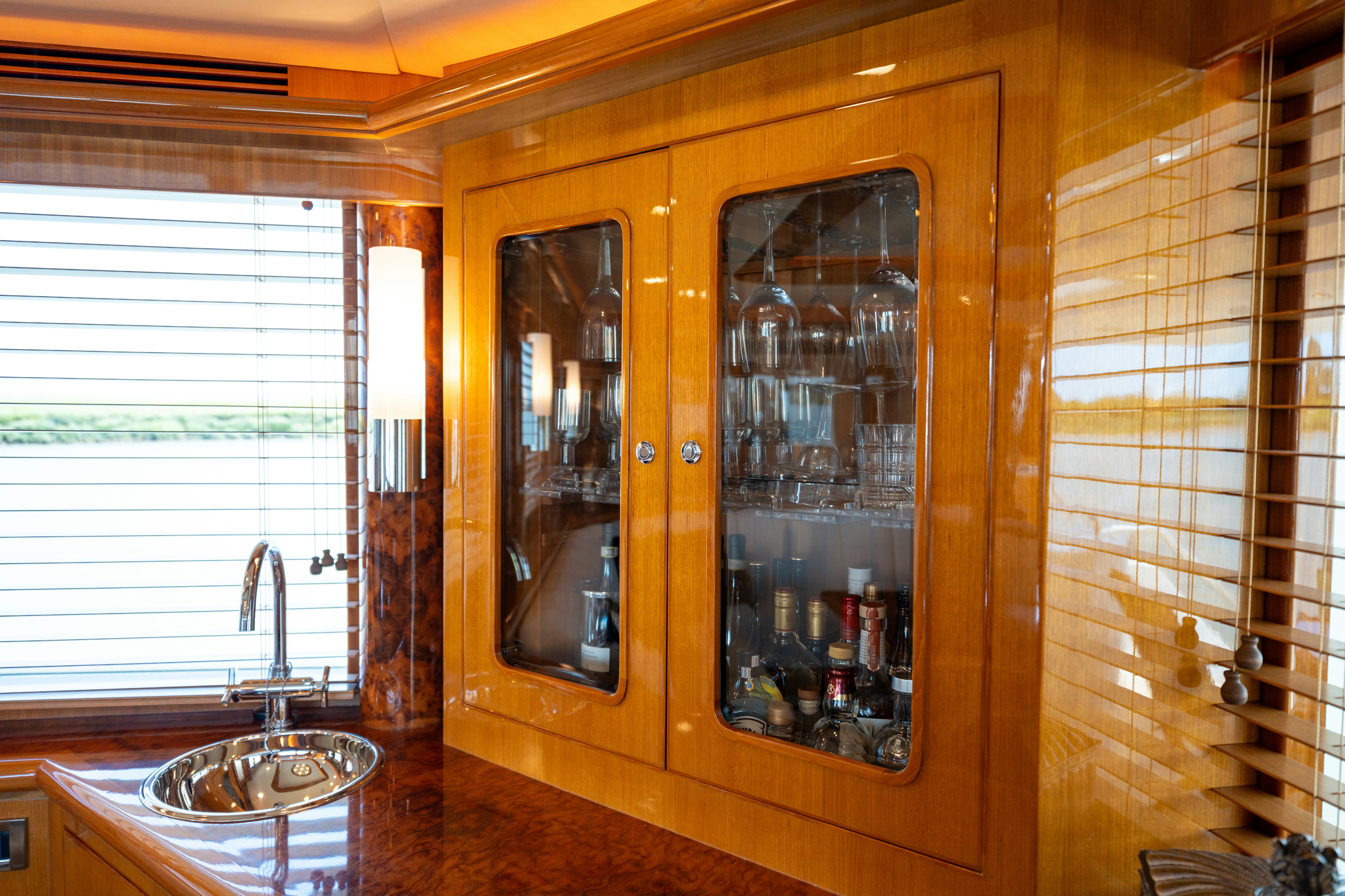 a glass cabinet with a sink and a mirror aboard MEMORY BANK Yacht for Sale