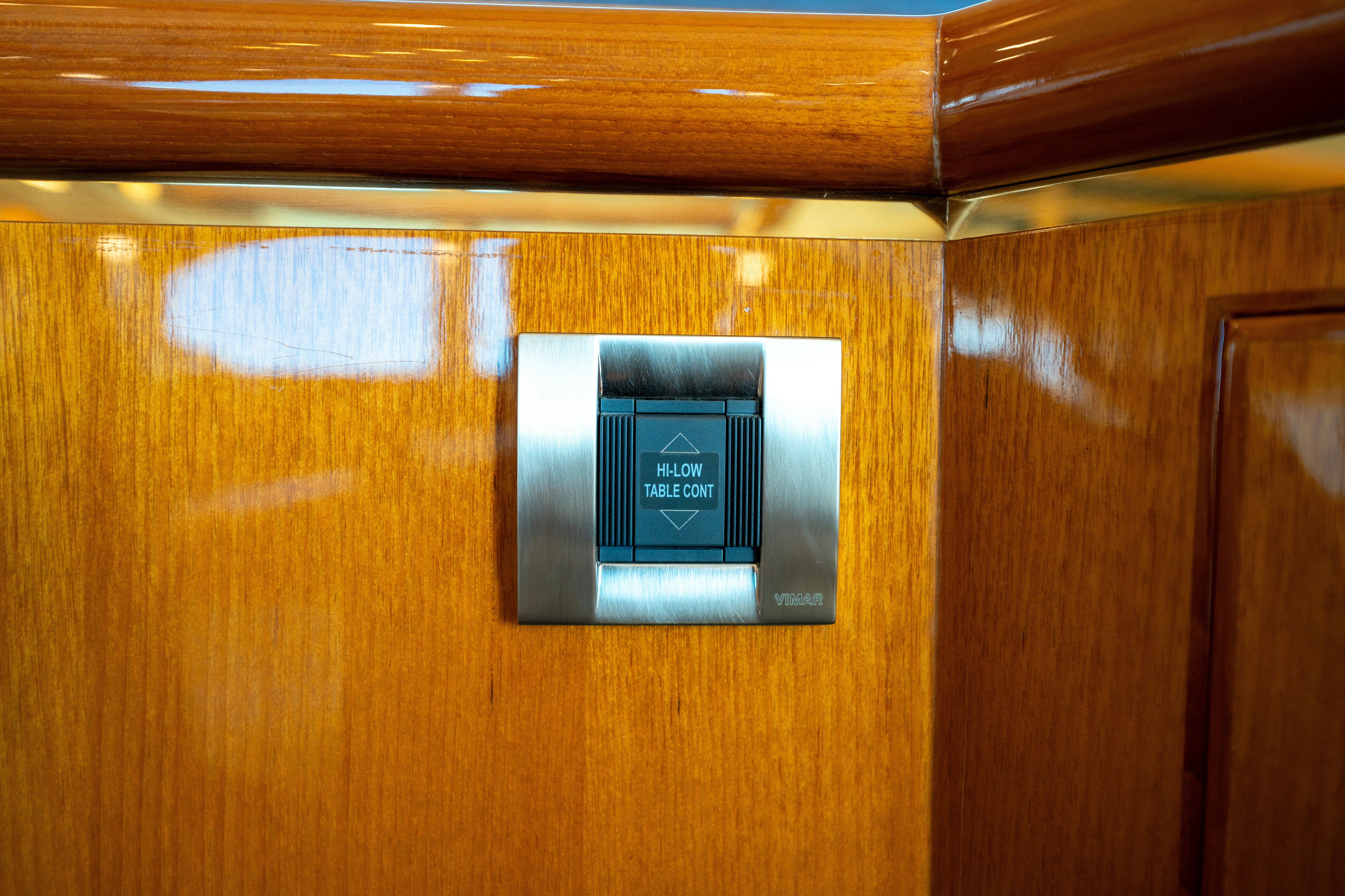 a computer on a wooden surface aboard MEMORY BANK Yacht for Sale