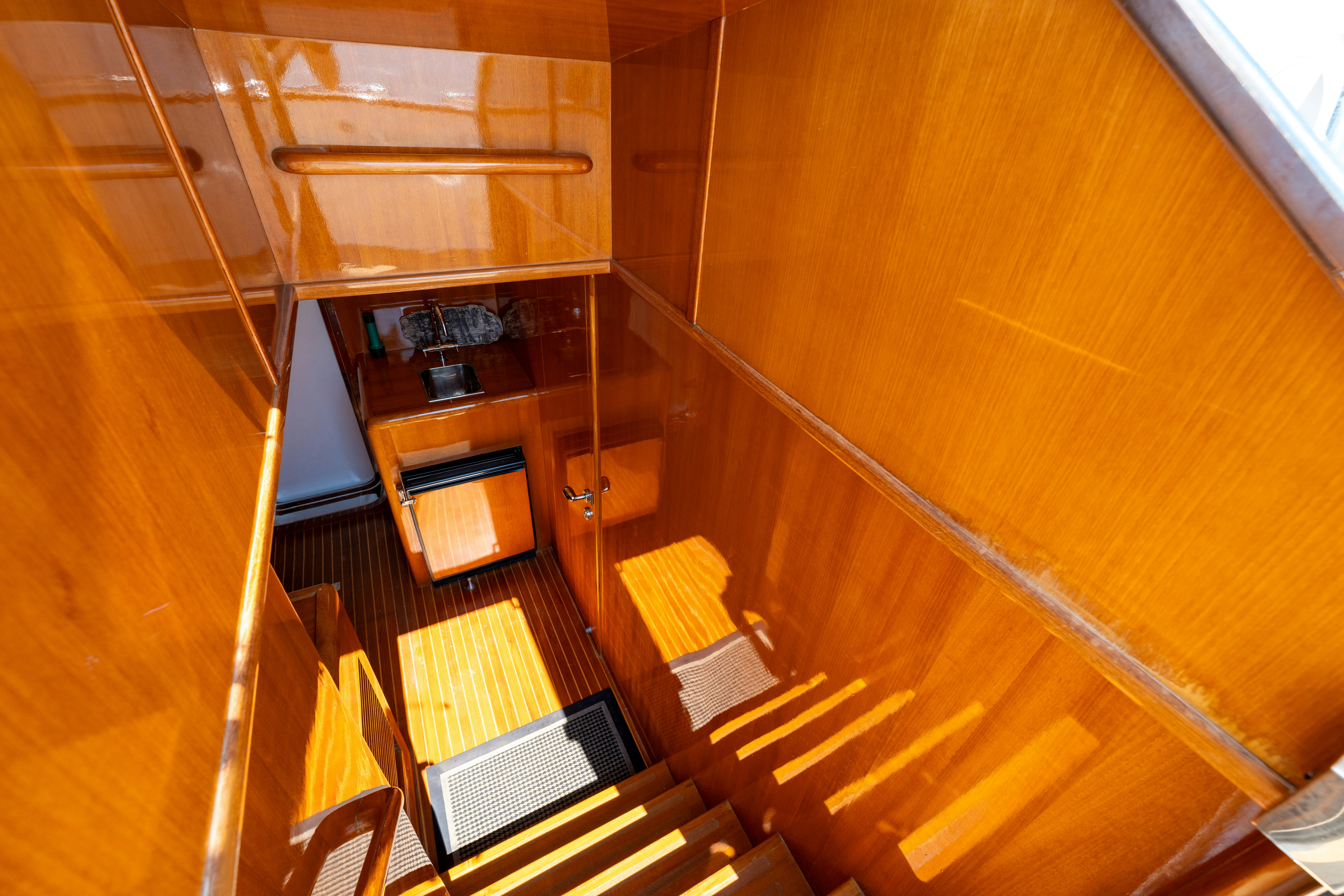 a wooden staircase with a wood railing aboard MEMORY BANK Yacht for Sale