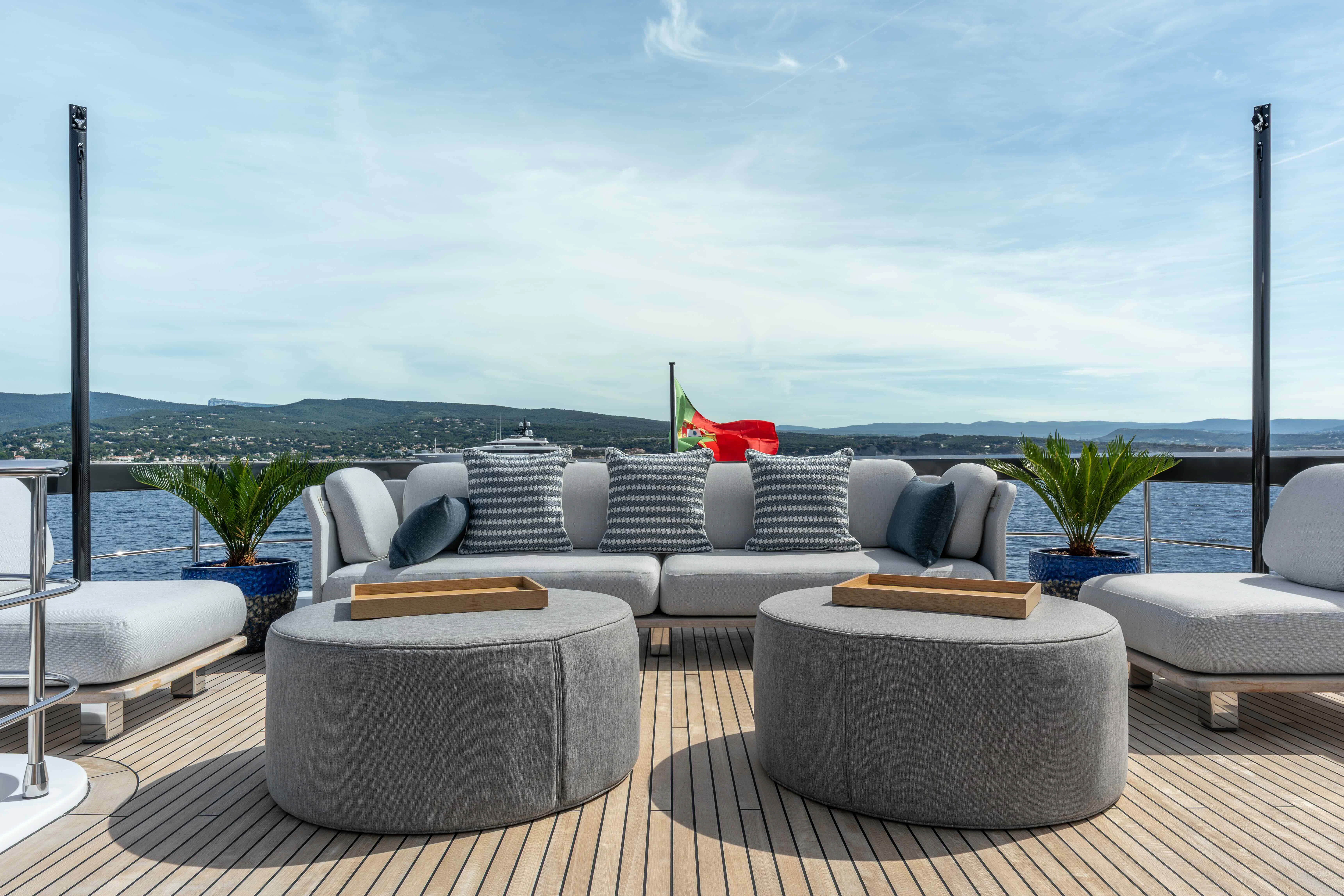 a living room with a large sofa and a large window aboard ST JUDE Yacht for Sale