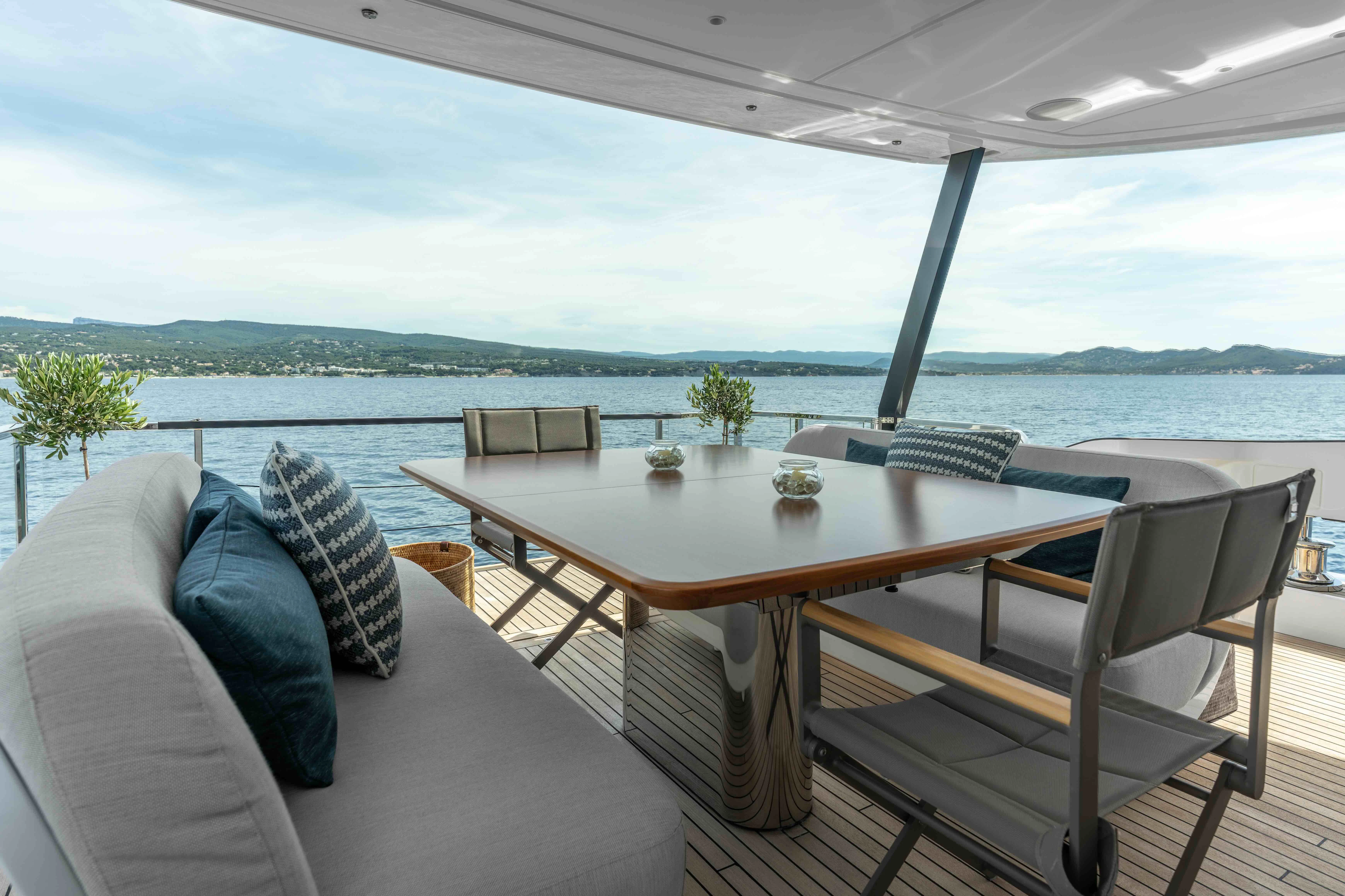 a table and chairs on a balcony aboard ST JUDE Yacht for Sale