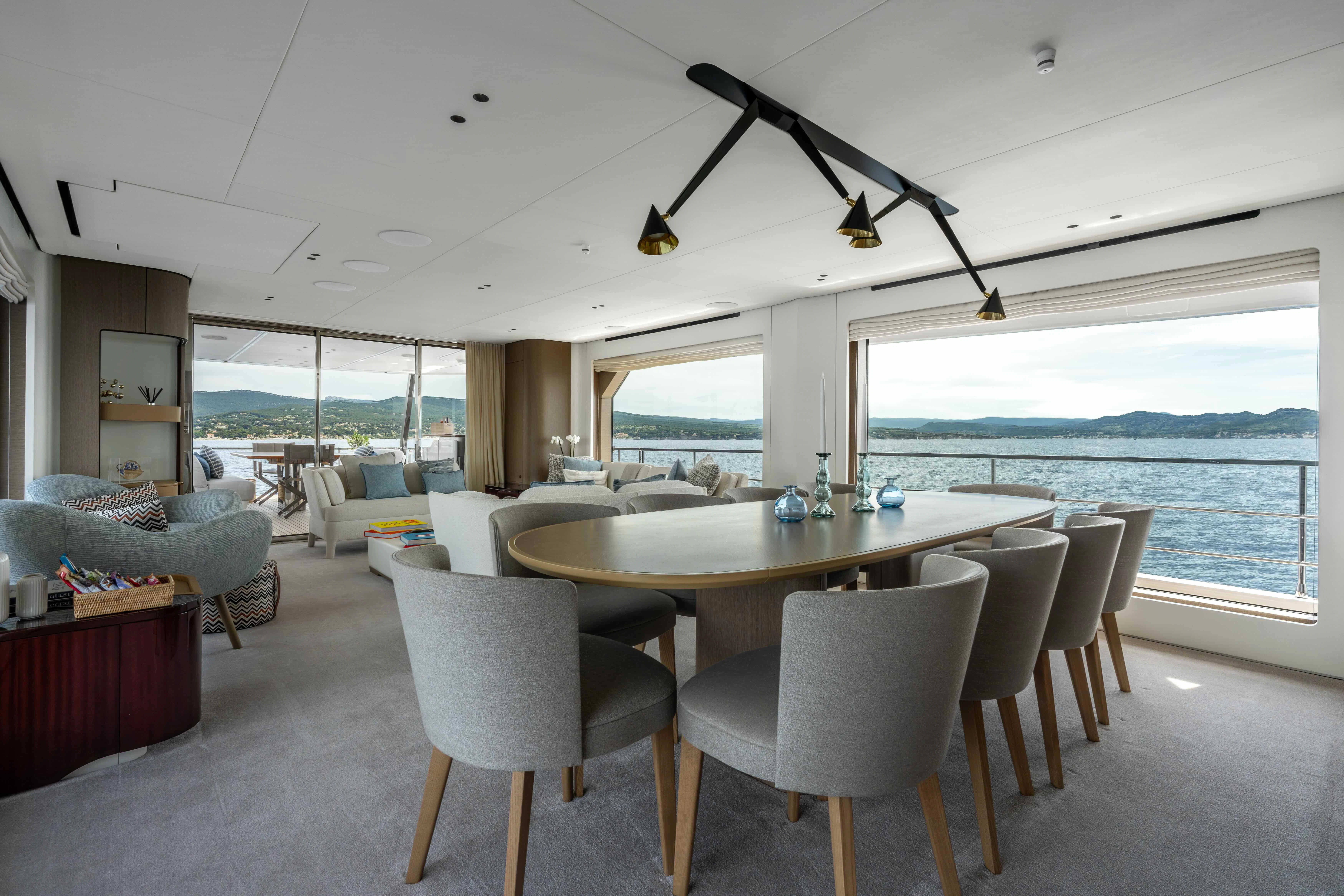 a dining room table with chairs and a fan aboard ST JUDE Yacht for Sale