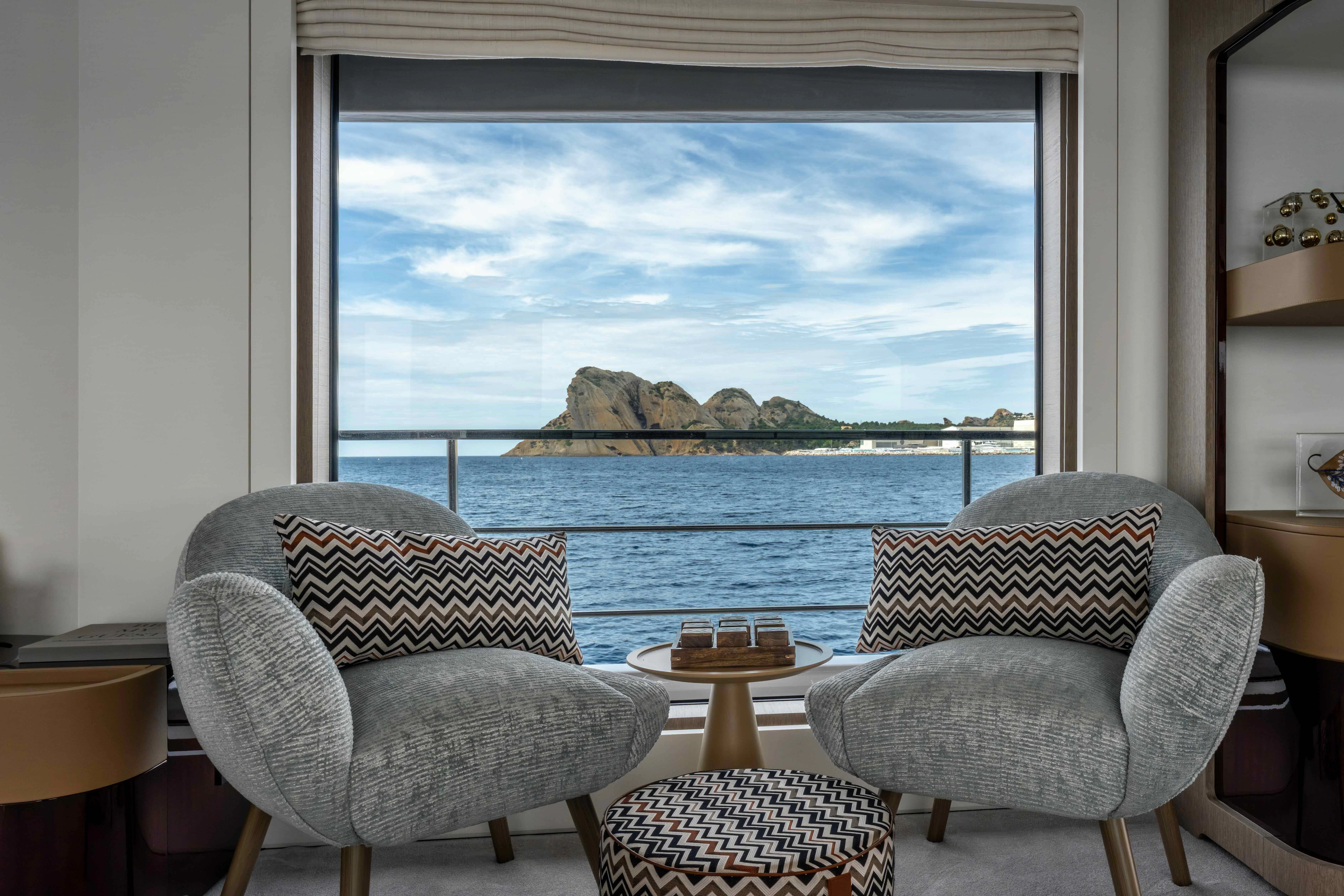 a room with a view of the ocean and a beach aboard ST JUDE Yacht for Sale