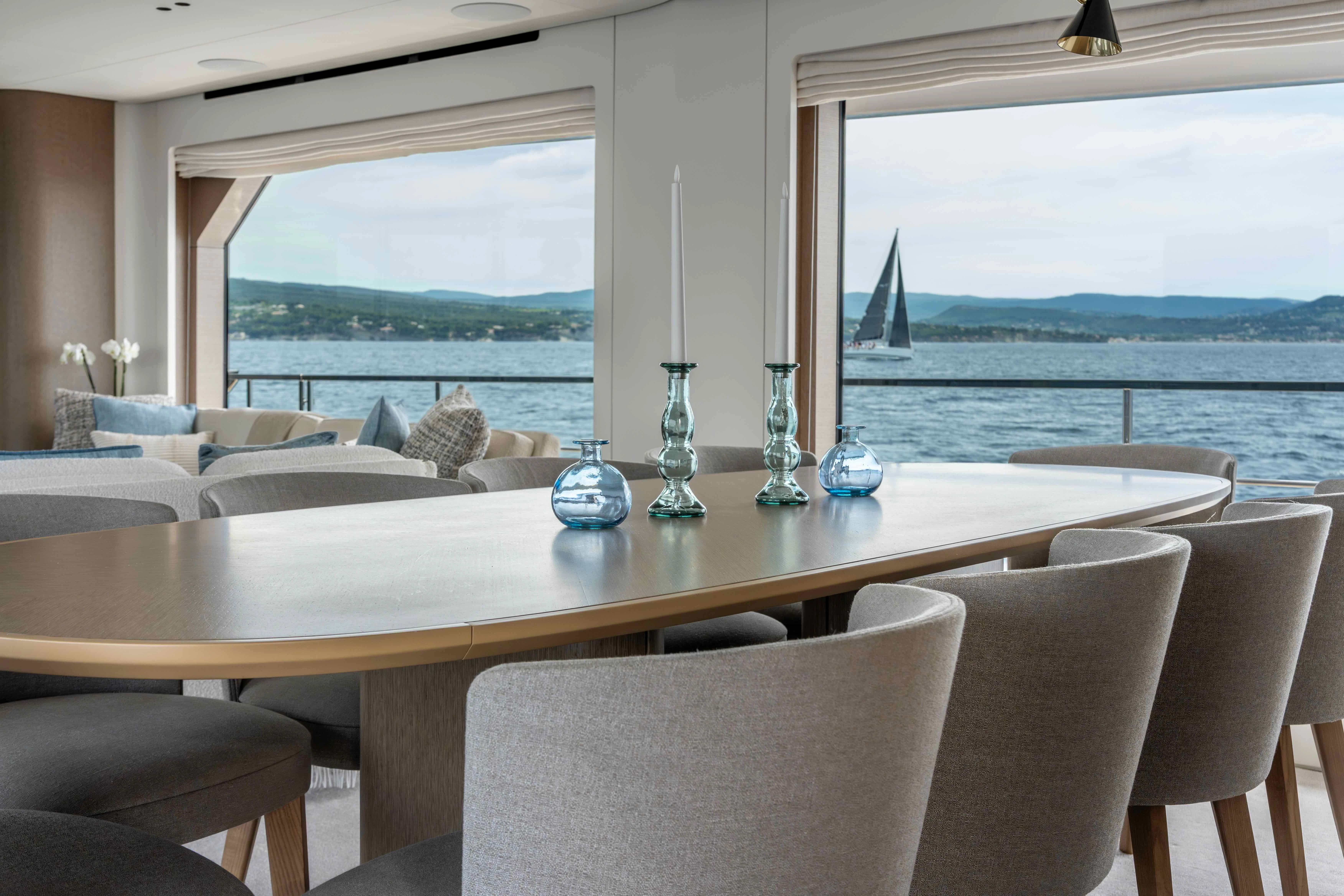 a table with chairs and a window aboard ST JUDE Yacht for Sale