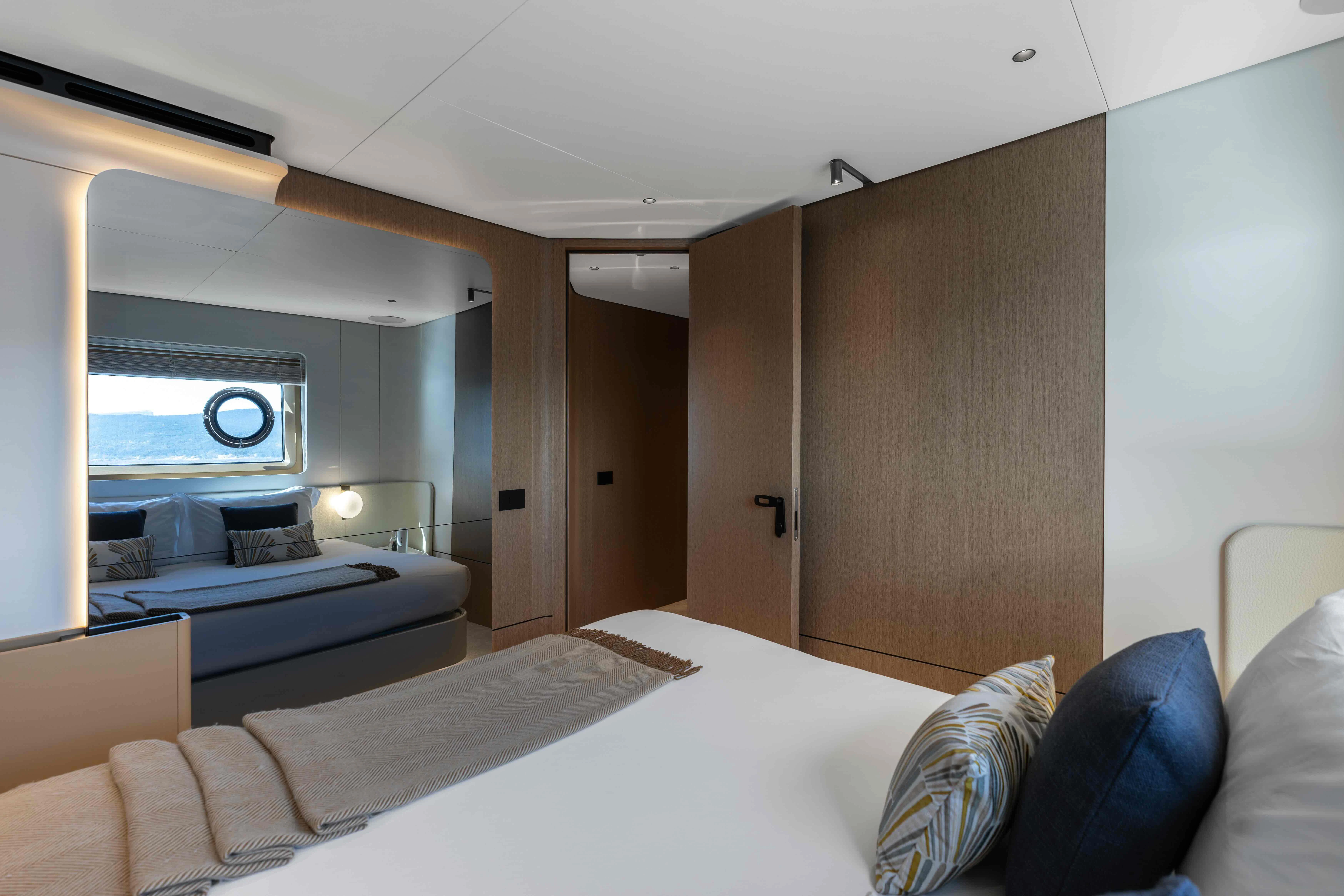a room with a bed and a large mirror aboard ST JUDE Yacht for Sale