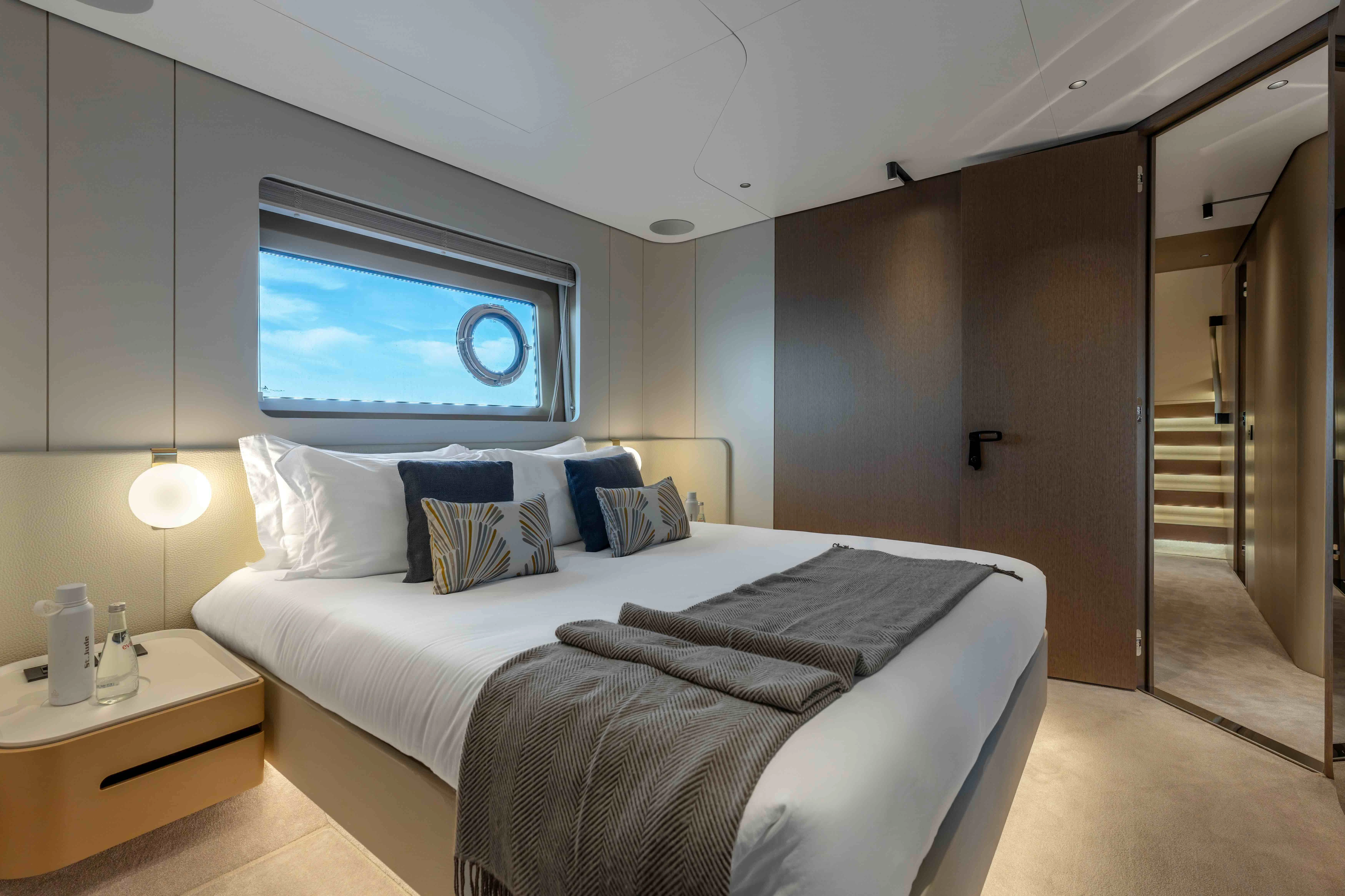 a bedroom with a bed and a television aboard ST JUDE Yacht for Sale