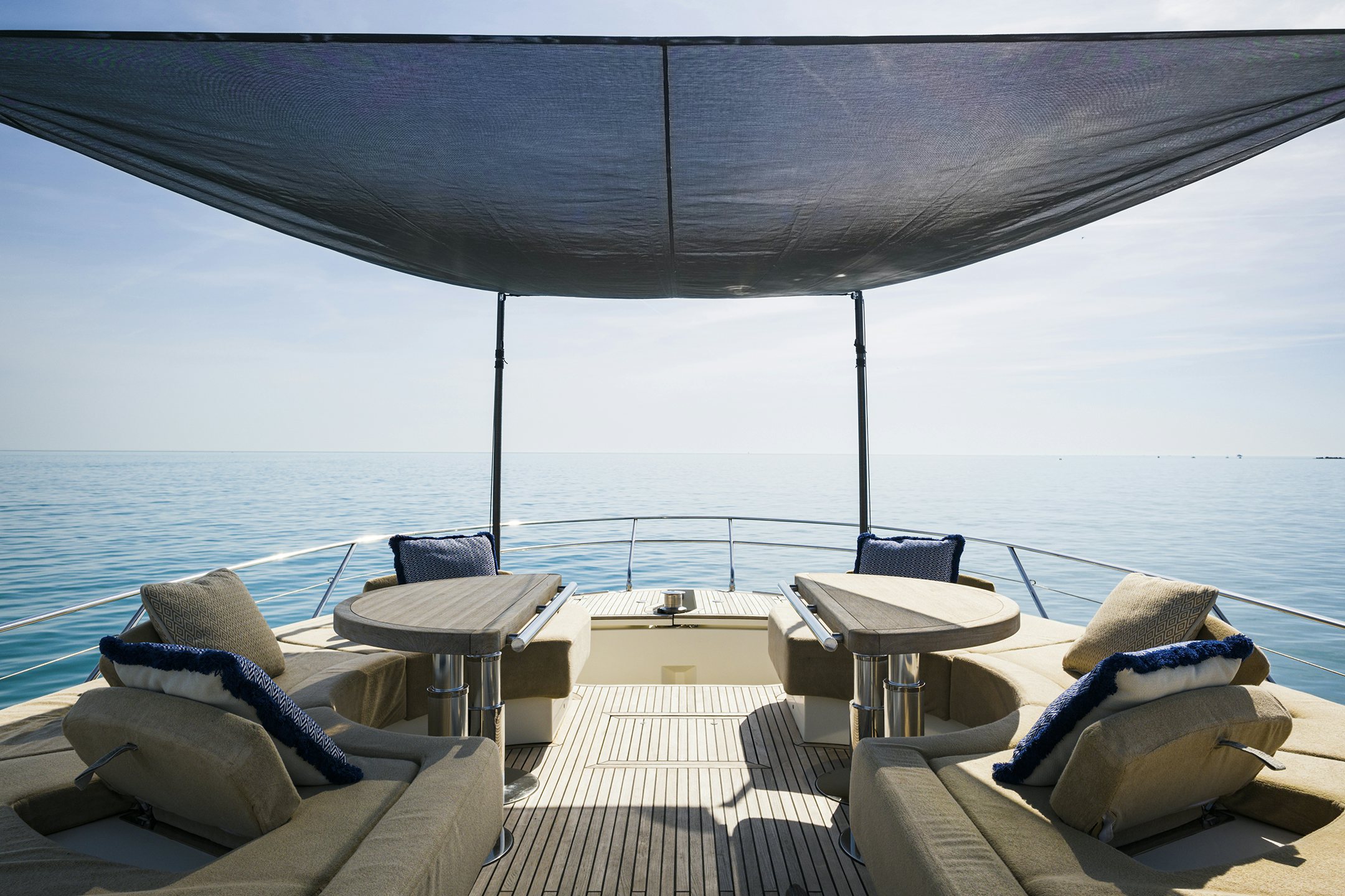 a patio with a table and chairs on it by the water aboard CRAZY DIAMOND Yacht for Sale