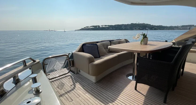 a table and chairs on a deck overlooking a body of water aboard CRAZY DIAMOND Yacht for Sale