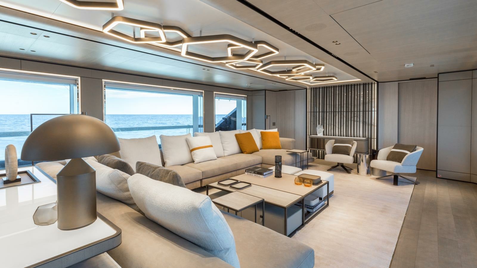 a large living room with a large window aboard AKULA Yacht for Charter