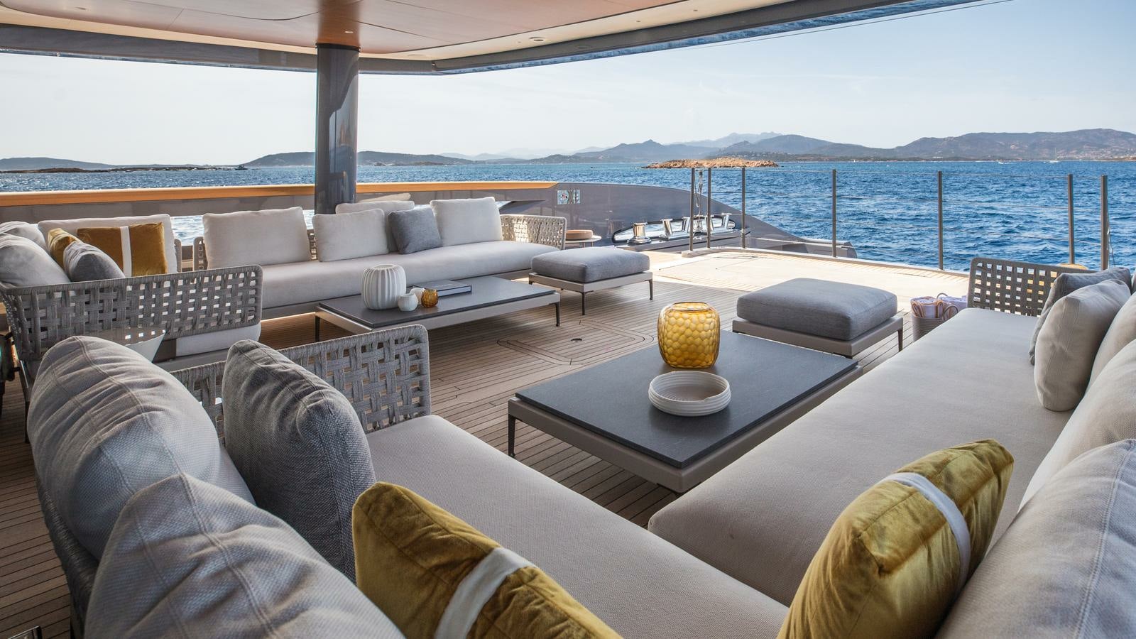 a large living room with a large body of water aboard AKULA Yacht for Charter