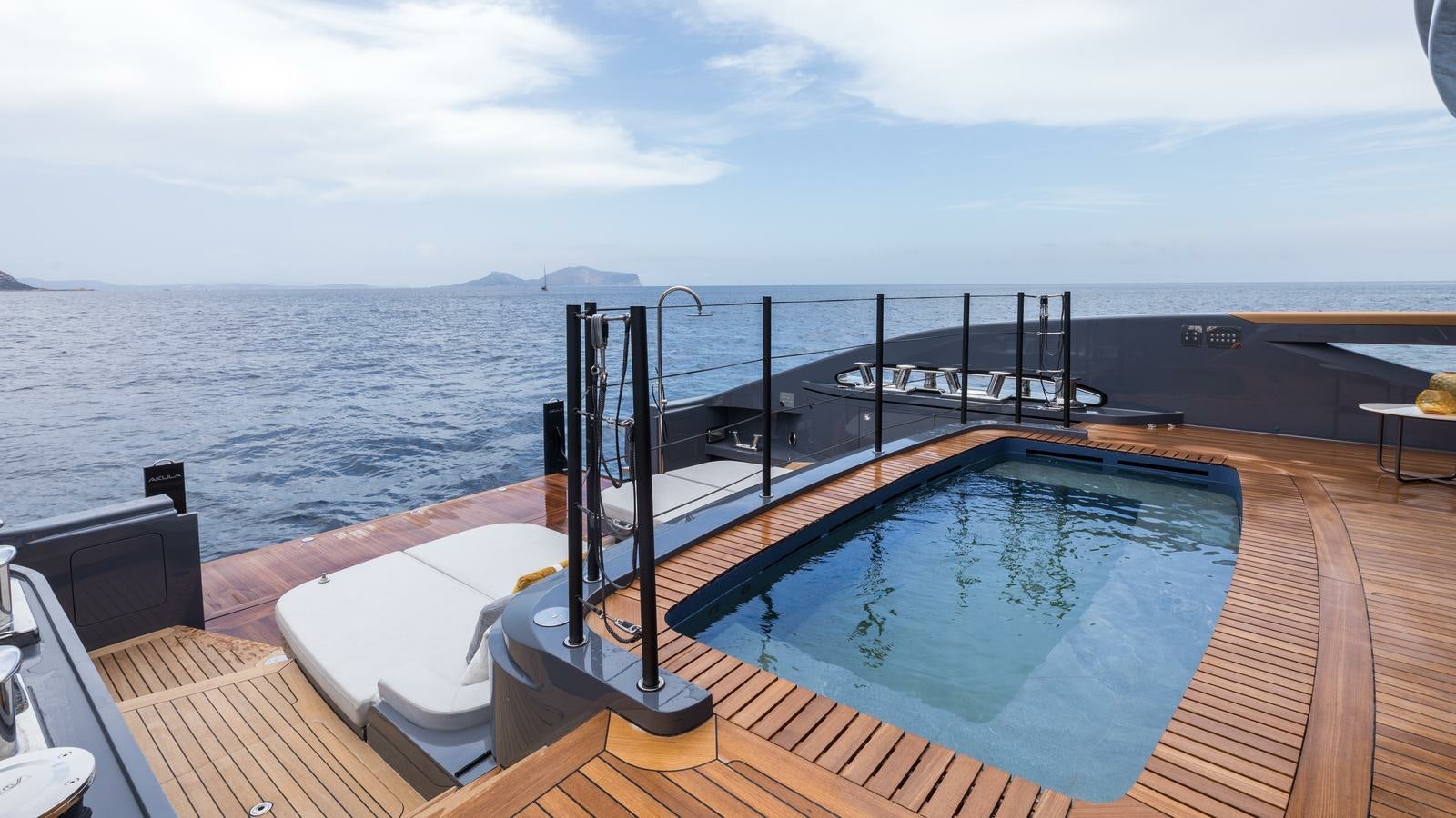 a large deck overlooking a large body of water aboard AKULA Yacht for Charter