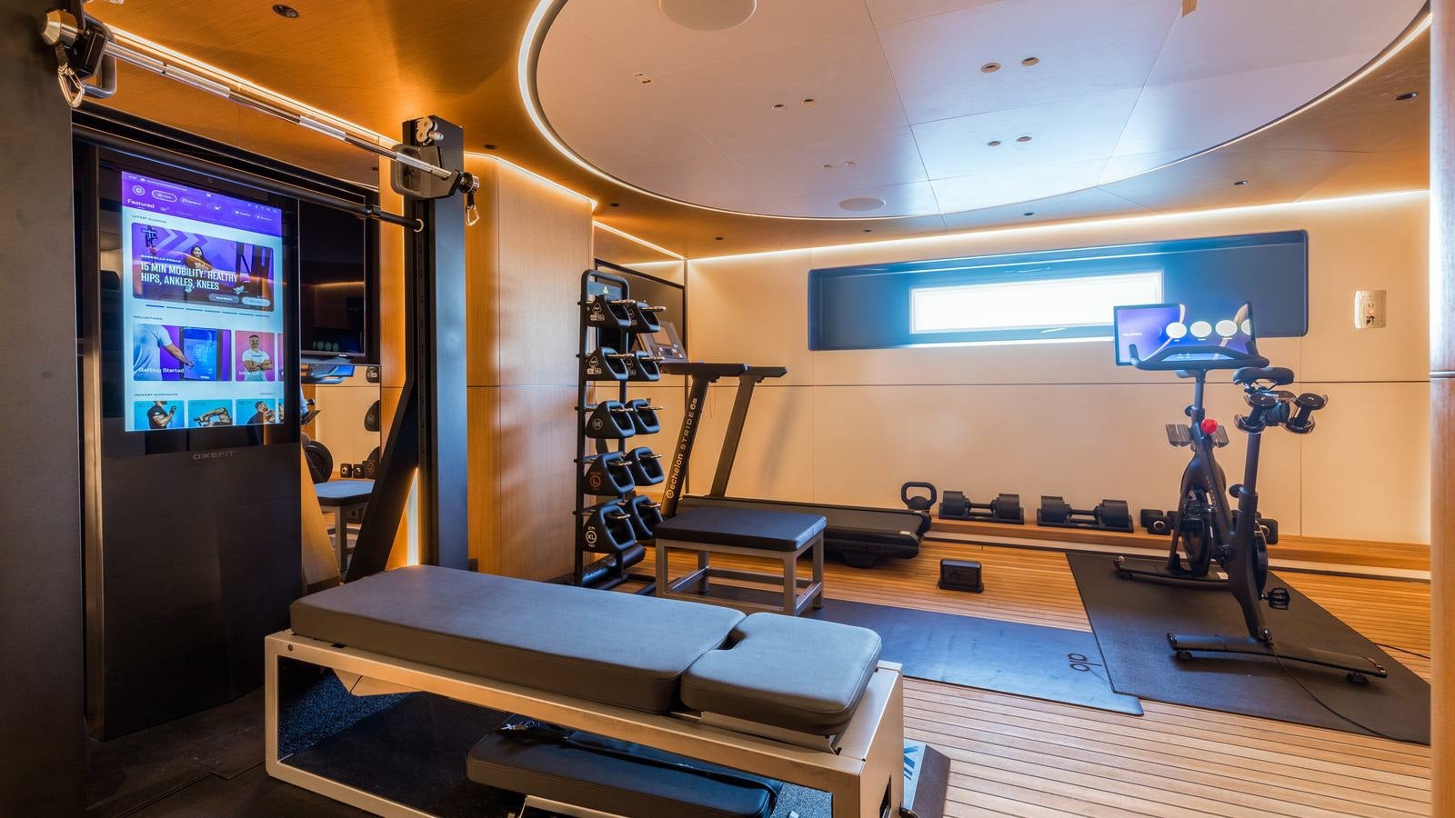 a gym with exercise equipment aboard AKULA Yacht for Charter