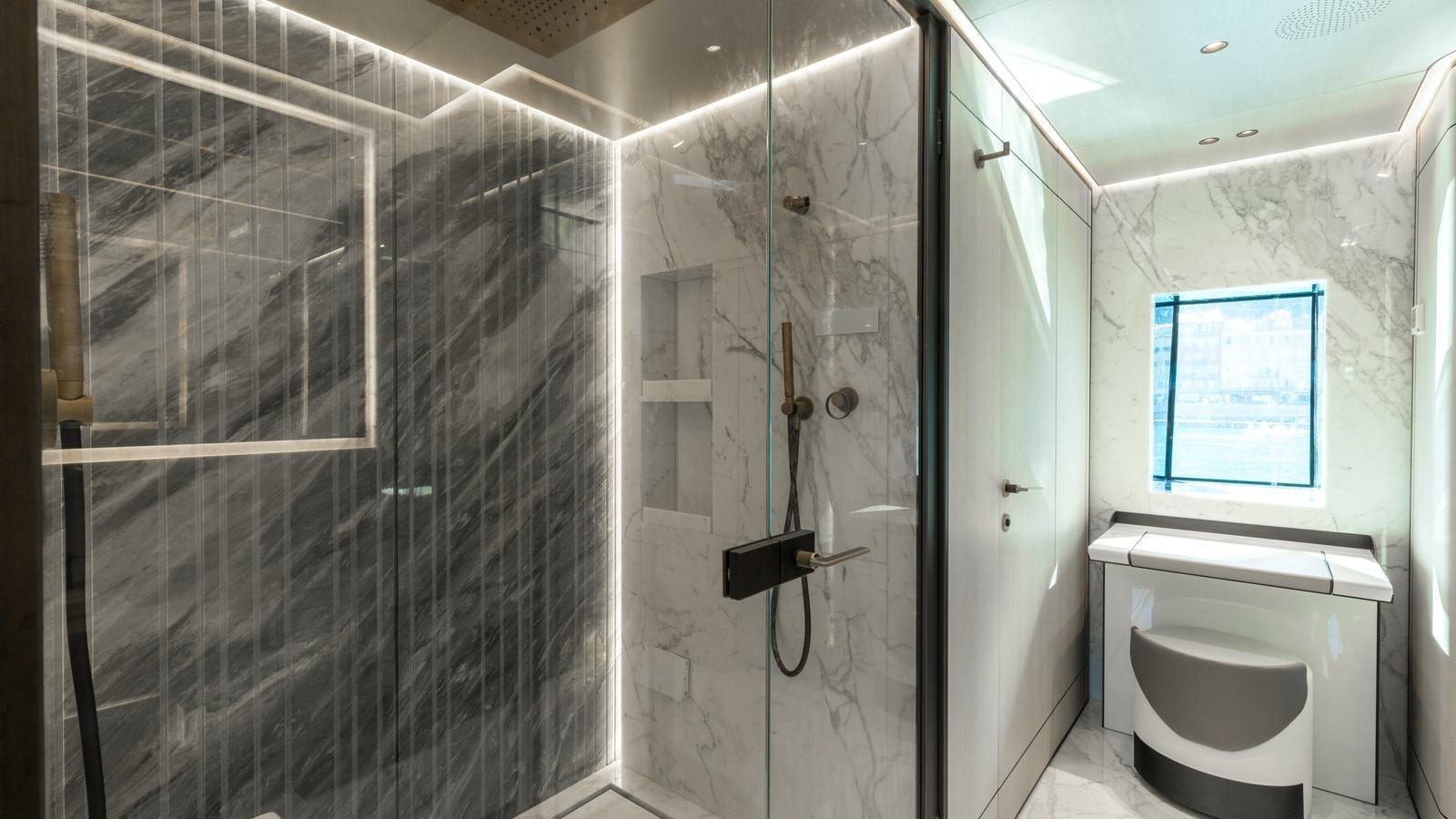 a bathroom with a glass shower aboard AKULA Yacht for Charter