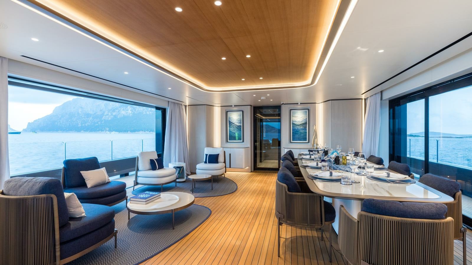 a large living room with a large window and a large patio with a large pool and a large aboard AKULA Yacht for Charter