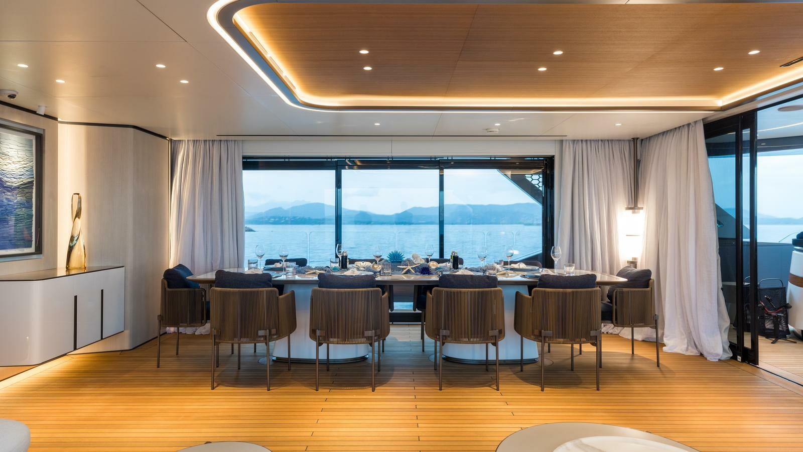 a large room with a large table and chairs aboard AKULA Yacht for Charter
