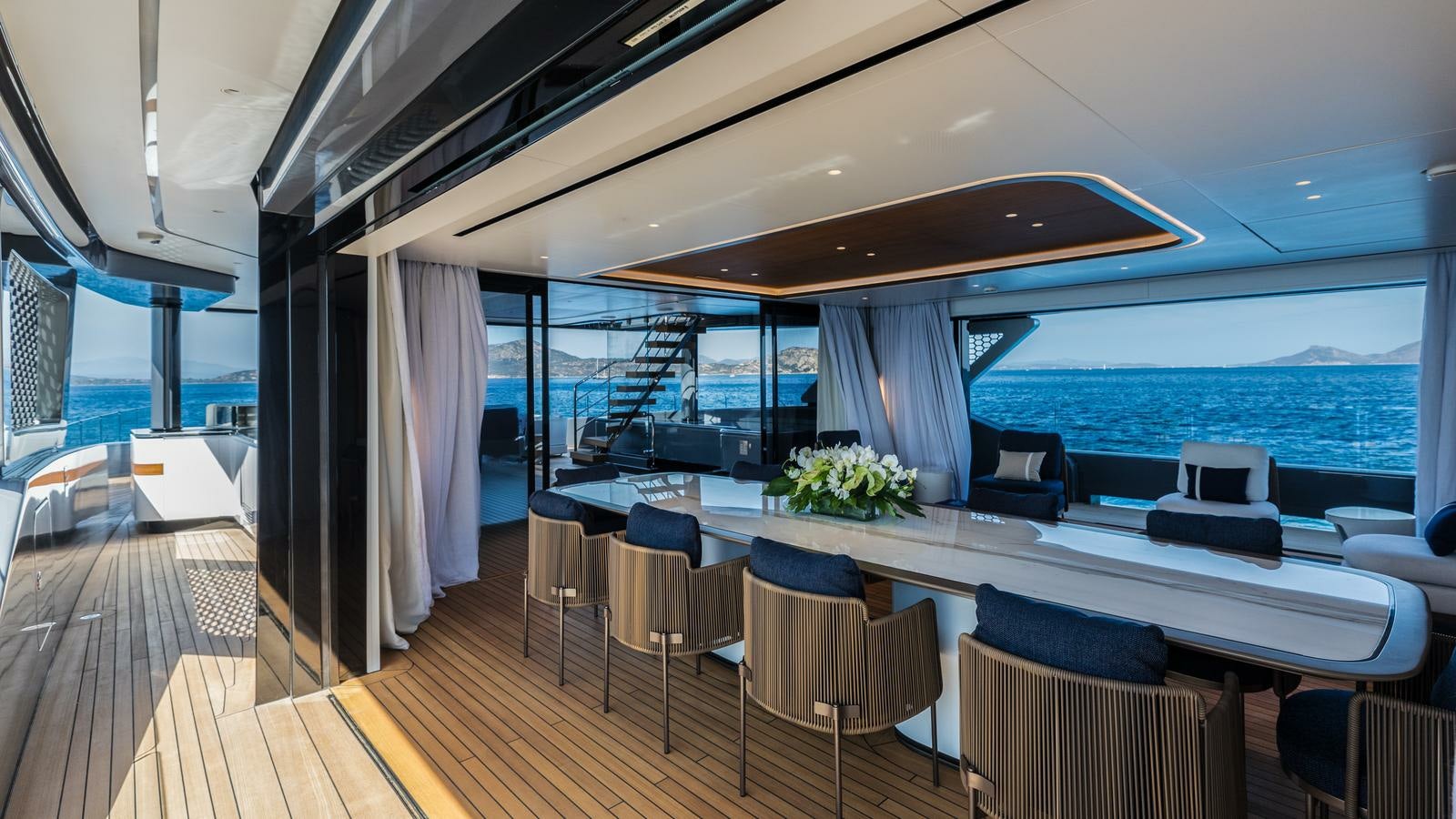 a large room with a large balcony overlooking the ocean aboard AKULA Yacht for Charter